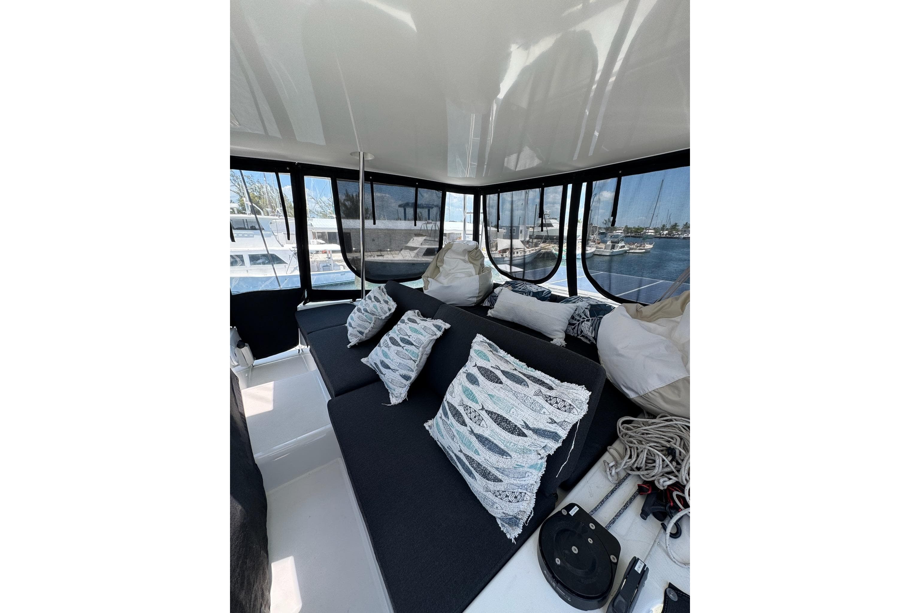Luxurious interior of 2020 Lagoon 46 catamaran with plush seating and decorative pillows.
