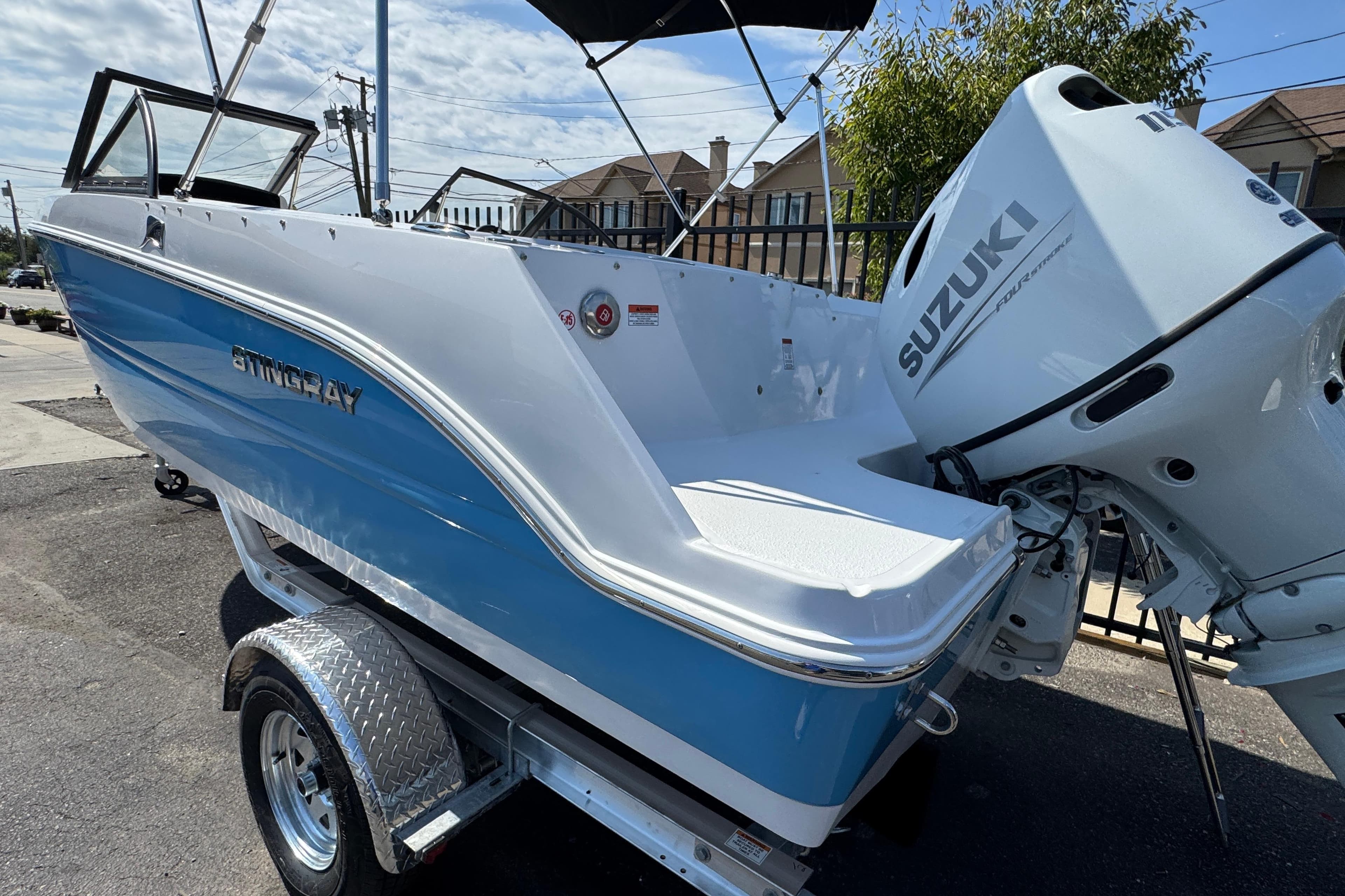 2026 Stingray 172 SC boat with Suzuki outboard motor, parked on a trailer.