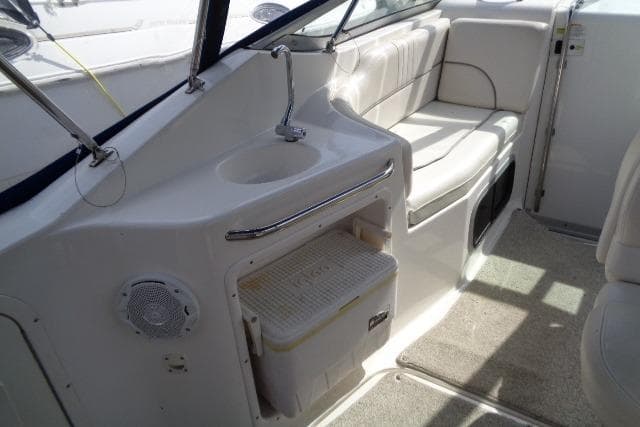 2006 Chaparral Signature 240 boat interior with seating, sink, and storage area.