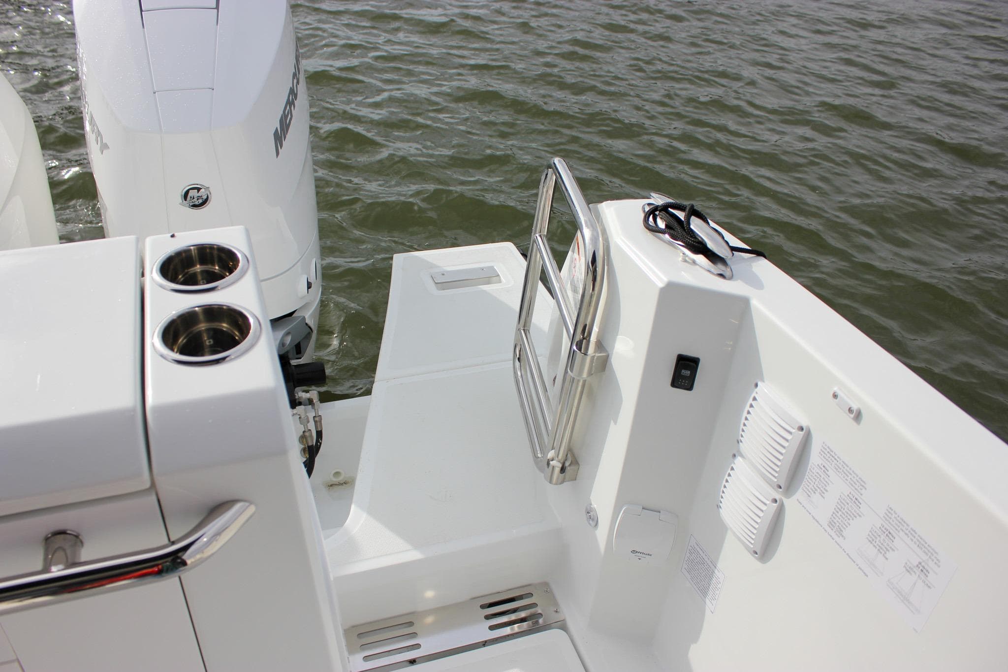 2026 Wellcraft 38 Explorer boat deck with Mercury outboard motor and stainless steel railings.
