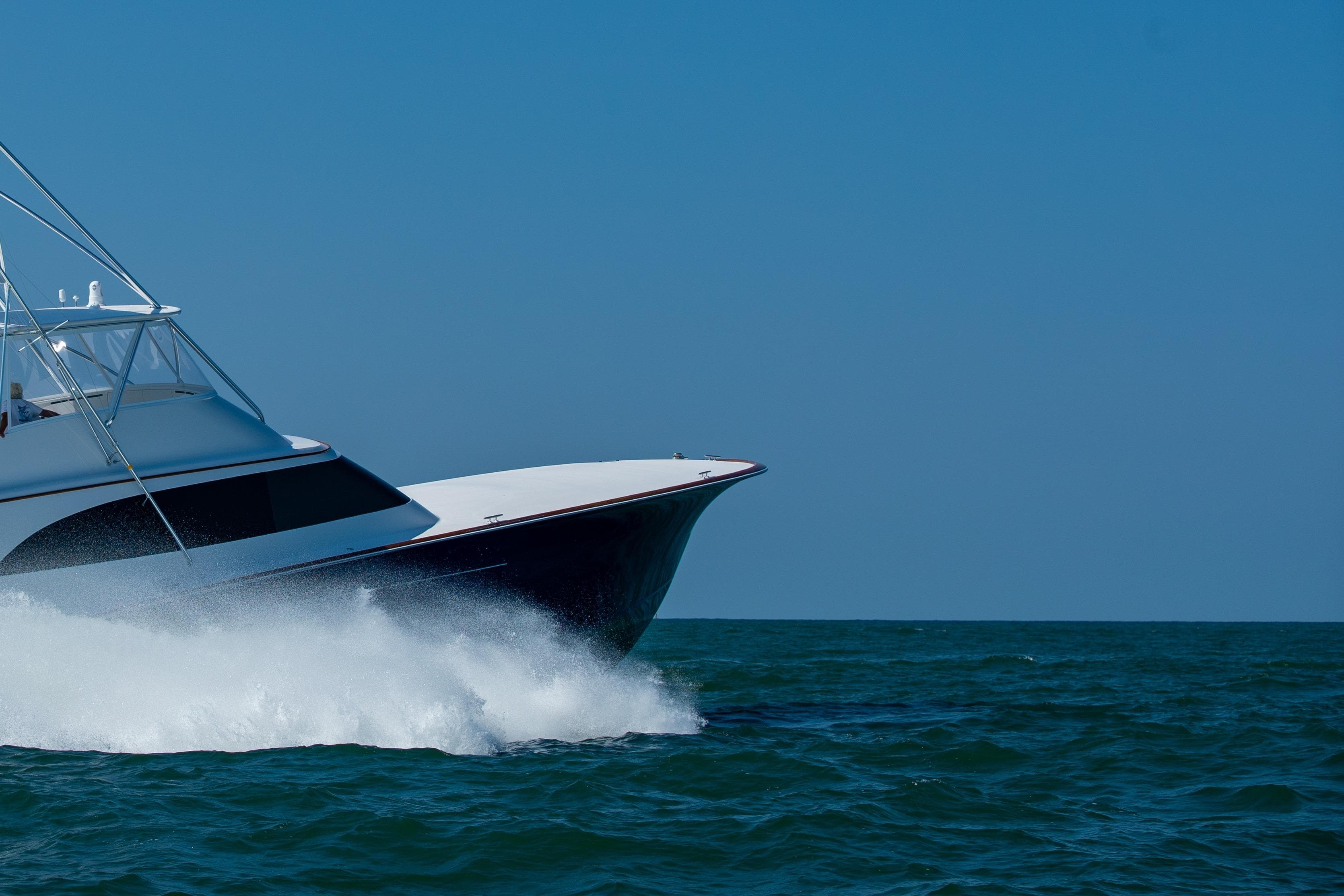 2020 Jarrett Bay 84 yacht cruising on open sea under clear blue sky.