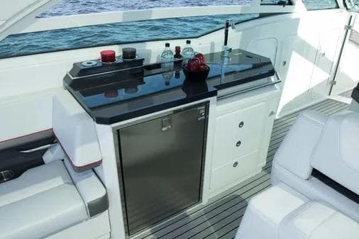 2019 Formula 430 Super Sport Crossover yacht interior with sleek kitchenette and seating.