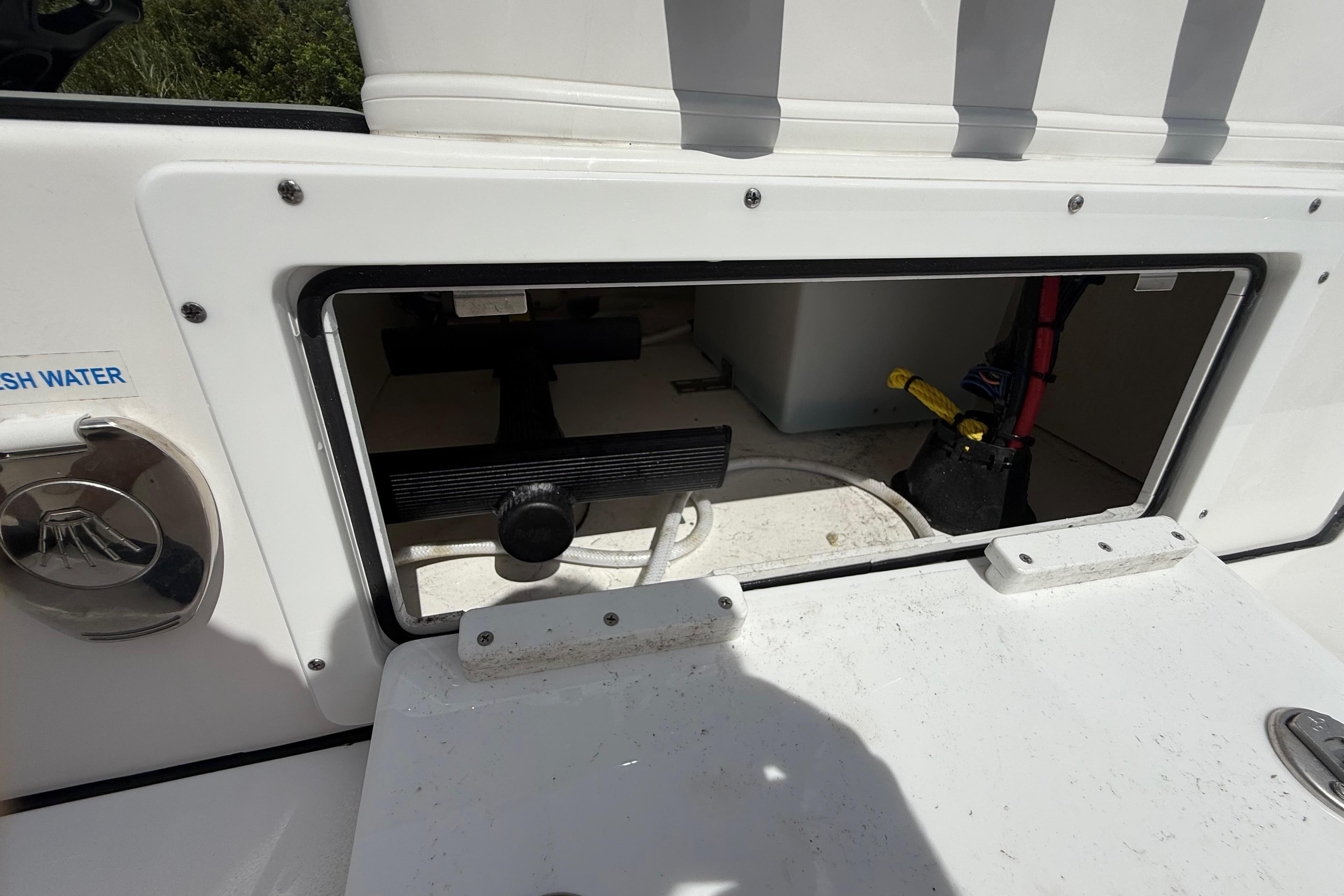 2025 Tidewater 25 TPC Raptor boat compartment with fresh water access and storage.