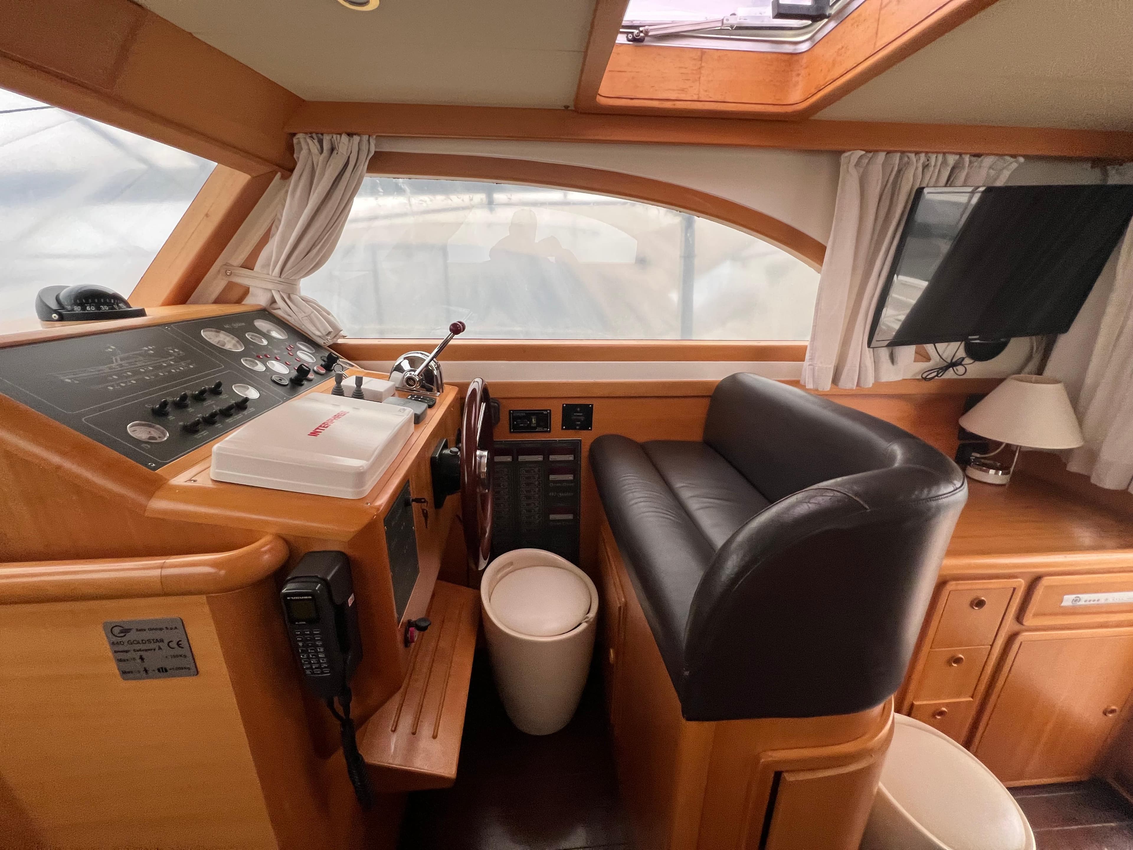 2007 Cantieri Estensi Goldstar 440 yacht interior with helm, seating, and navigation equipment.