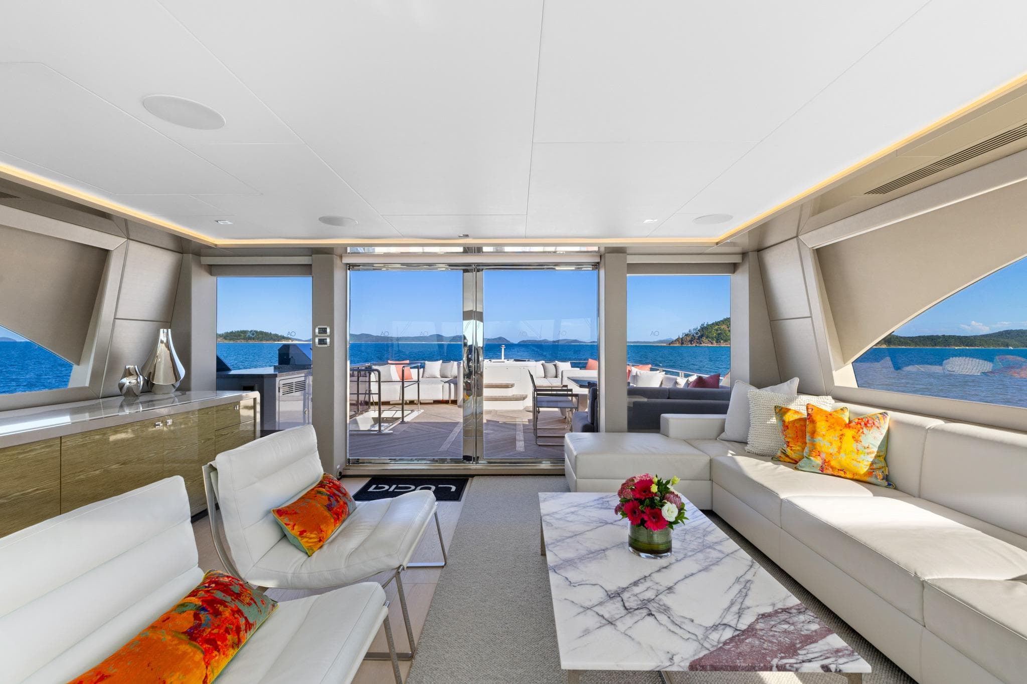 Luxurious interior of 2023 Ocean Alexander 28E yacht with elegant seating and ocean views.
