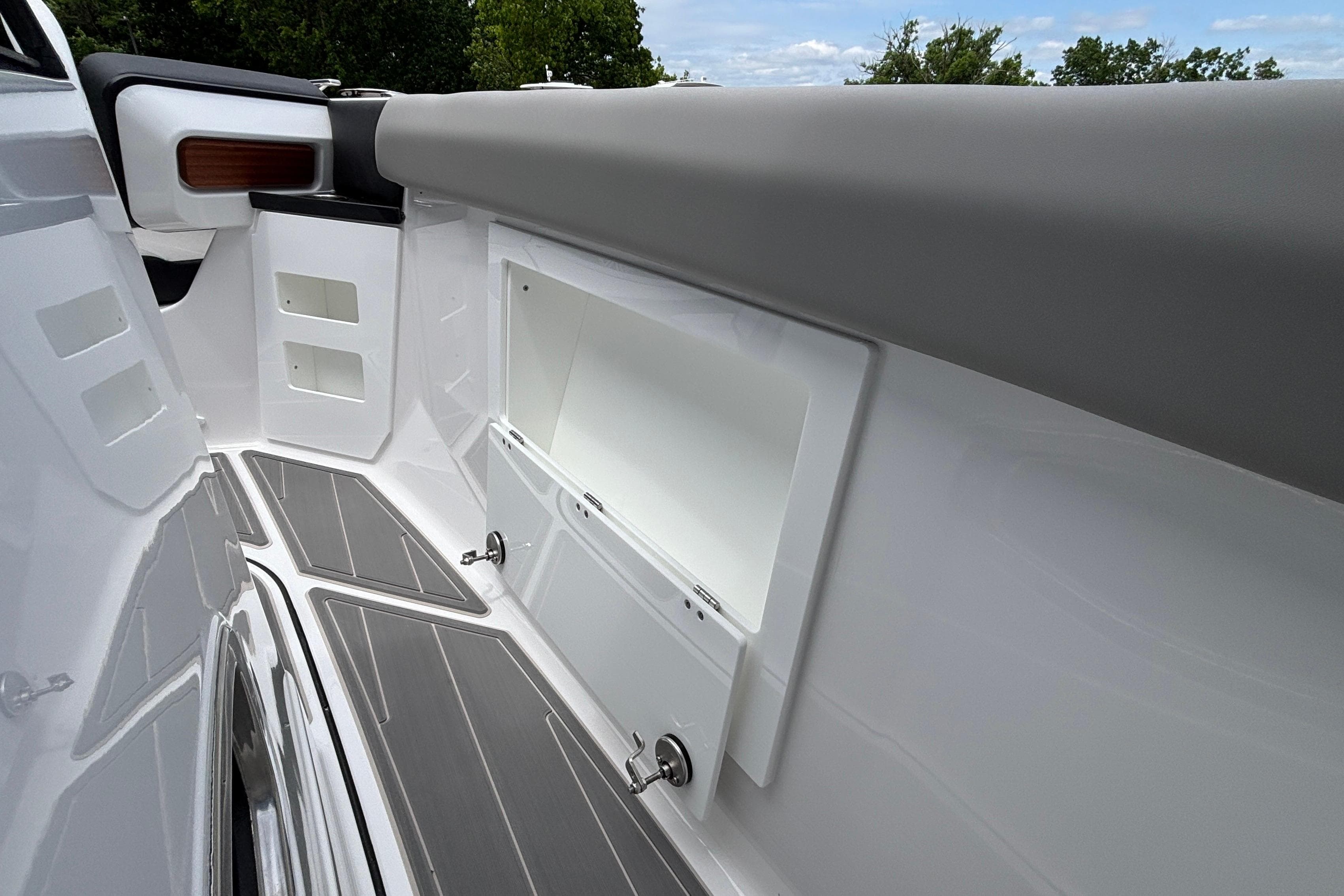 Interior view of 2026 Monterey Elite 30 OB boat, featuring sleek storage compartments and modern design.