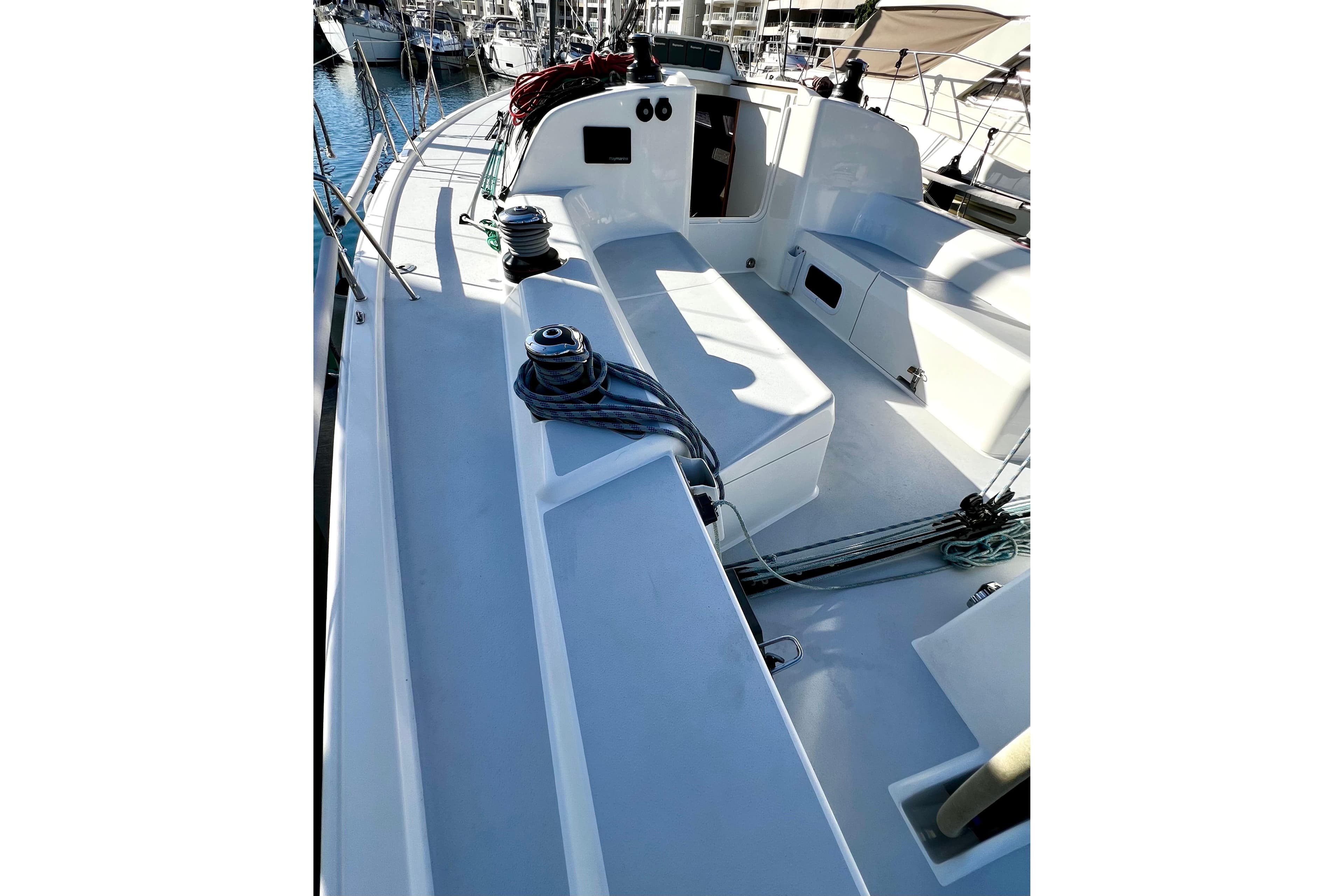2018 J-Composites J/112E sailboat deck with winches and seating in marina.