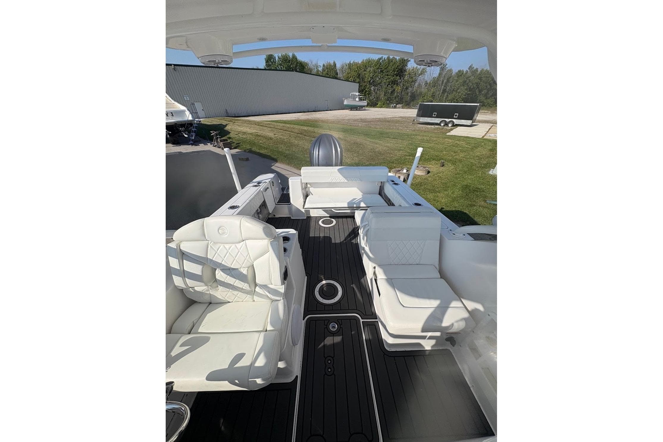 2023 Edgewater 248 CX boat interior with white seating and sleek black flooring.