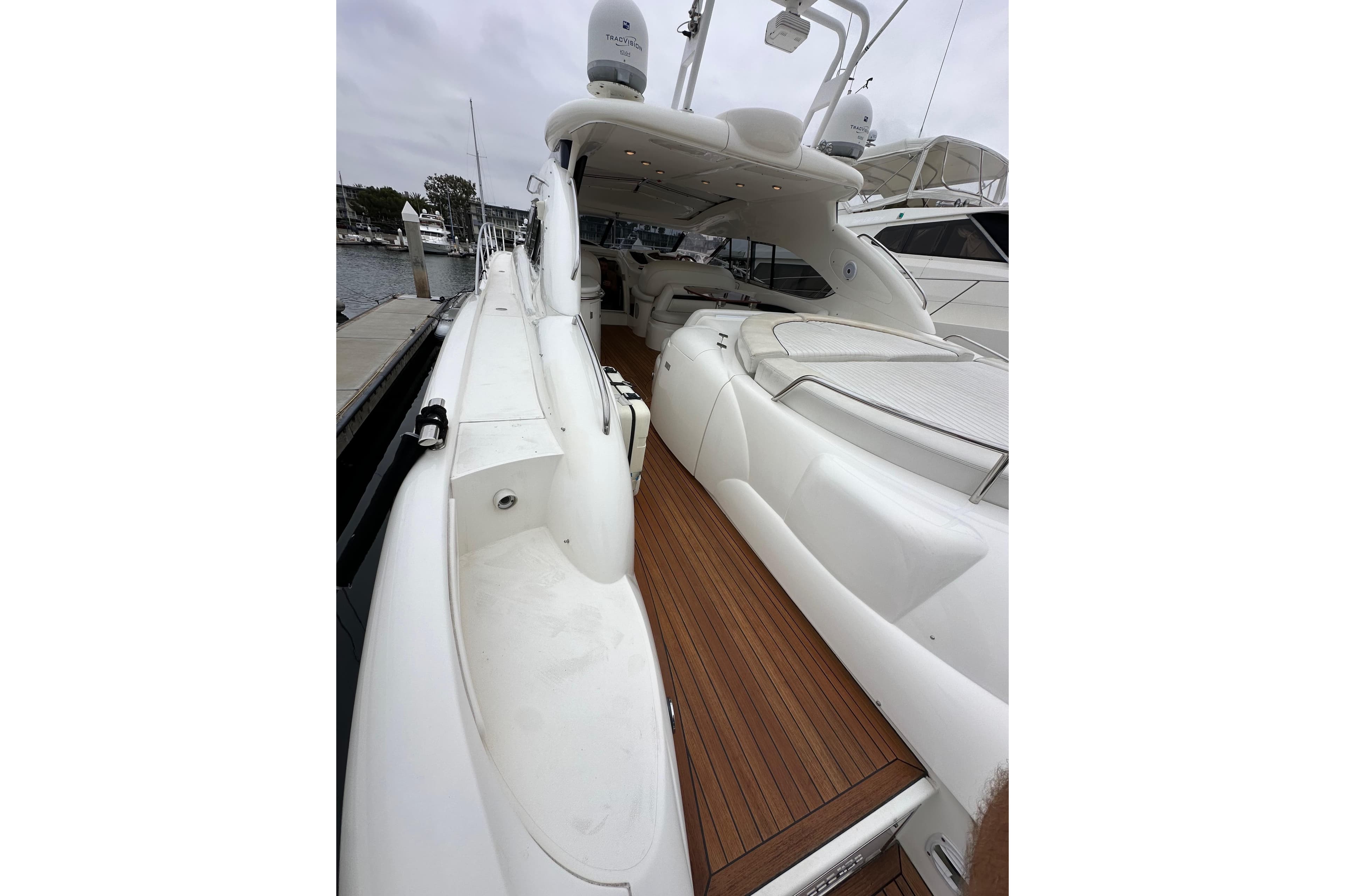 Sunseeker Predator 60 yacht, 2000 model, featuring sleek white design and wooden deck.