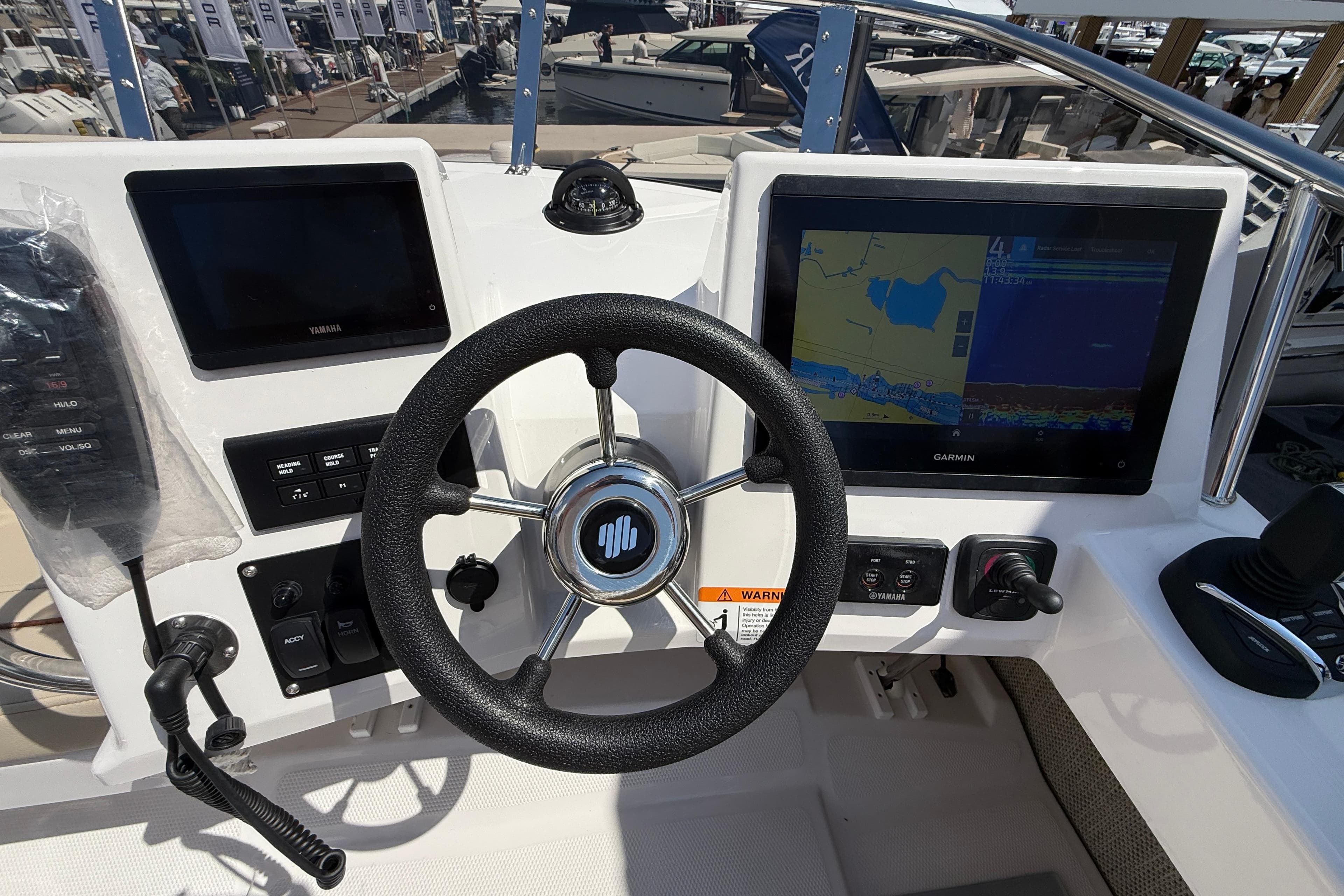 Steering console of 2026 Cutwater C-288 CB with Garmin navigation display.