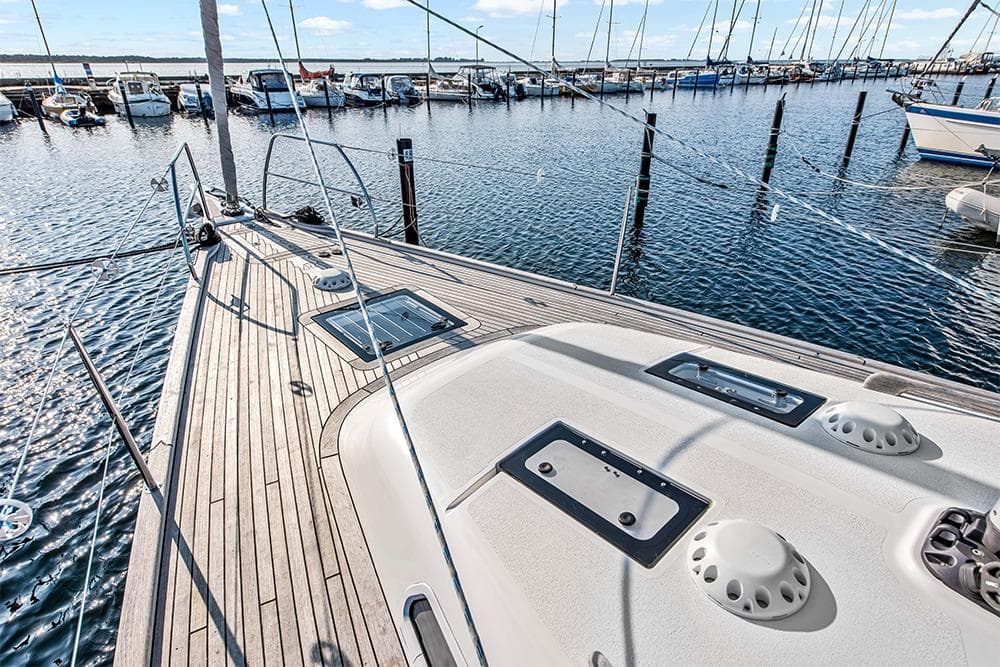 Deck of 2022 Hallberg-Rassy 400 yacht in marina, showcasing sleek design and craftsmanship.