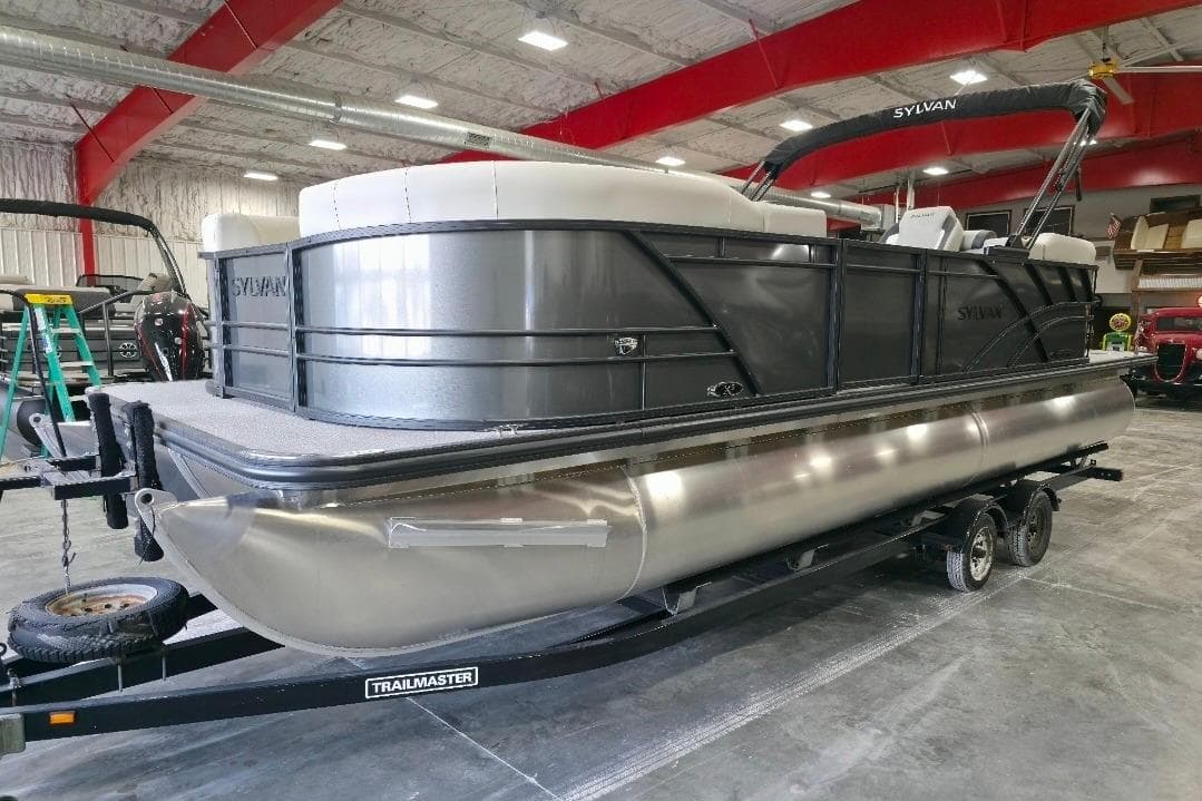 2026 Sylvan Mirage X5 pontoon boat on trailer in indoor storage facility.