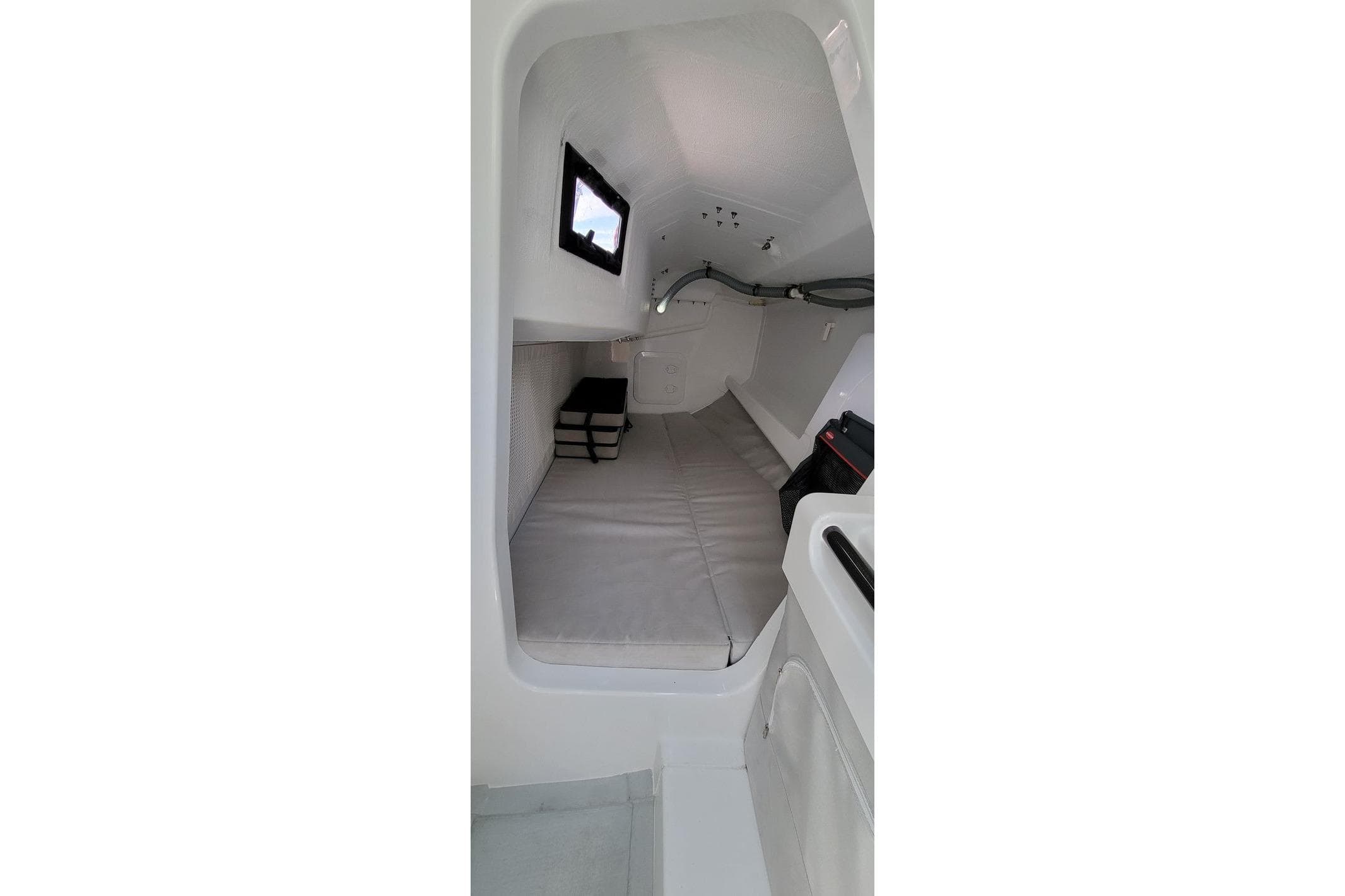 Interior cabin of 2020 Dehler 30 OD sailboat, featuring minimalist design and compact sleeping area.
