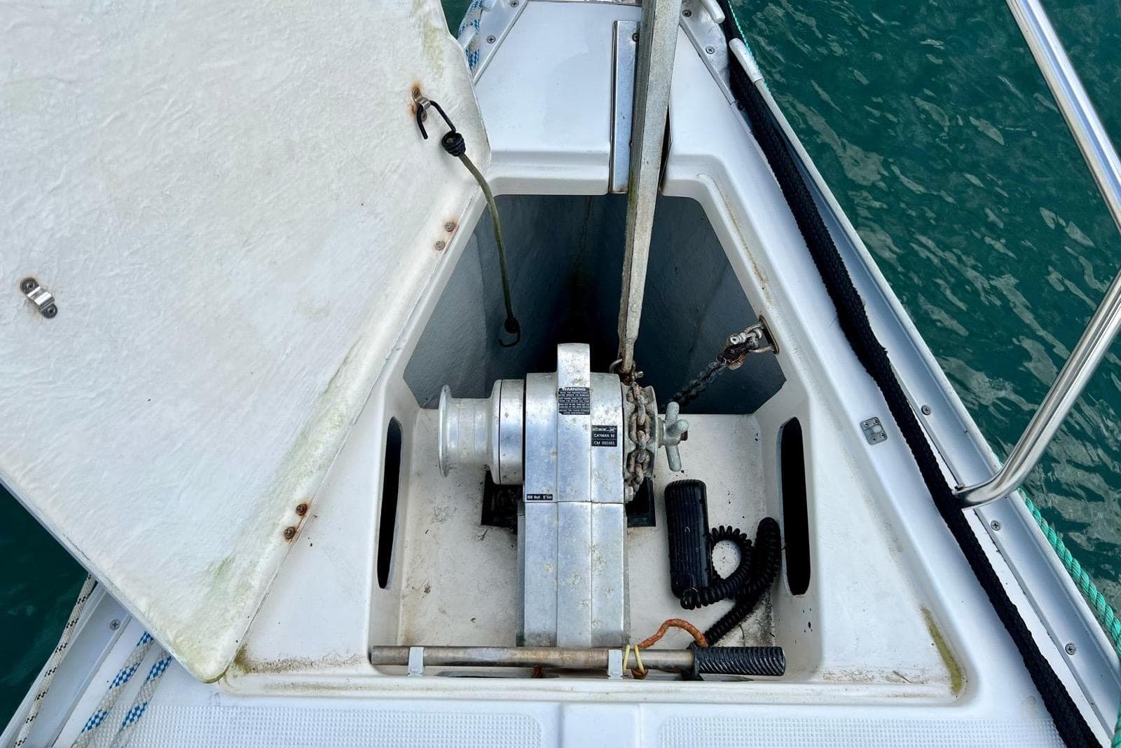 Anchor locker of a 2001 Bavaria 34 sailboat with winch and chain.