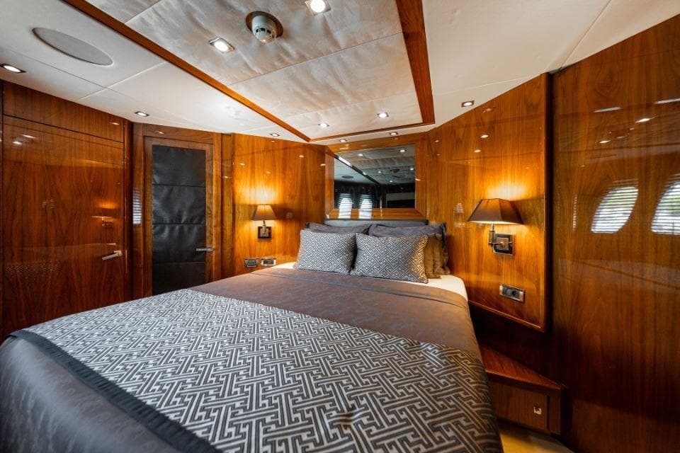 Luxurious bedroom interior of 2009 Sunseeker 34 Metre Yacht with elegant wood paneling.