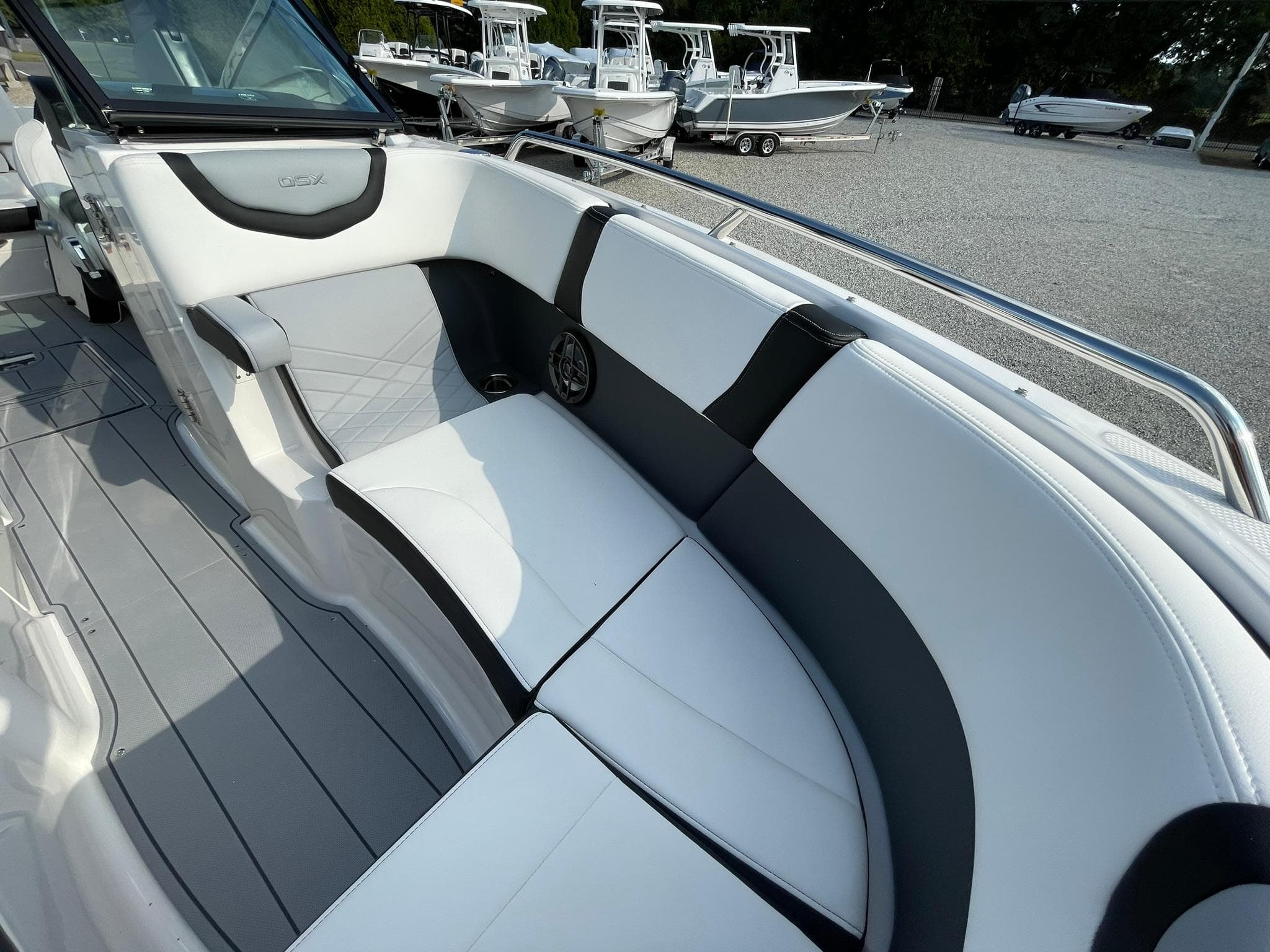 2025 Chaparral 270 OSX boat interior with sleek white and black seating.