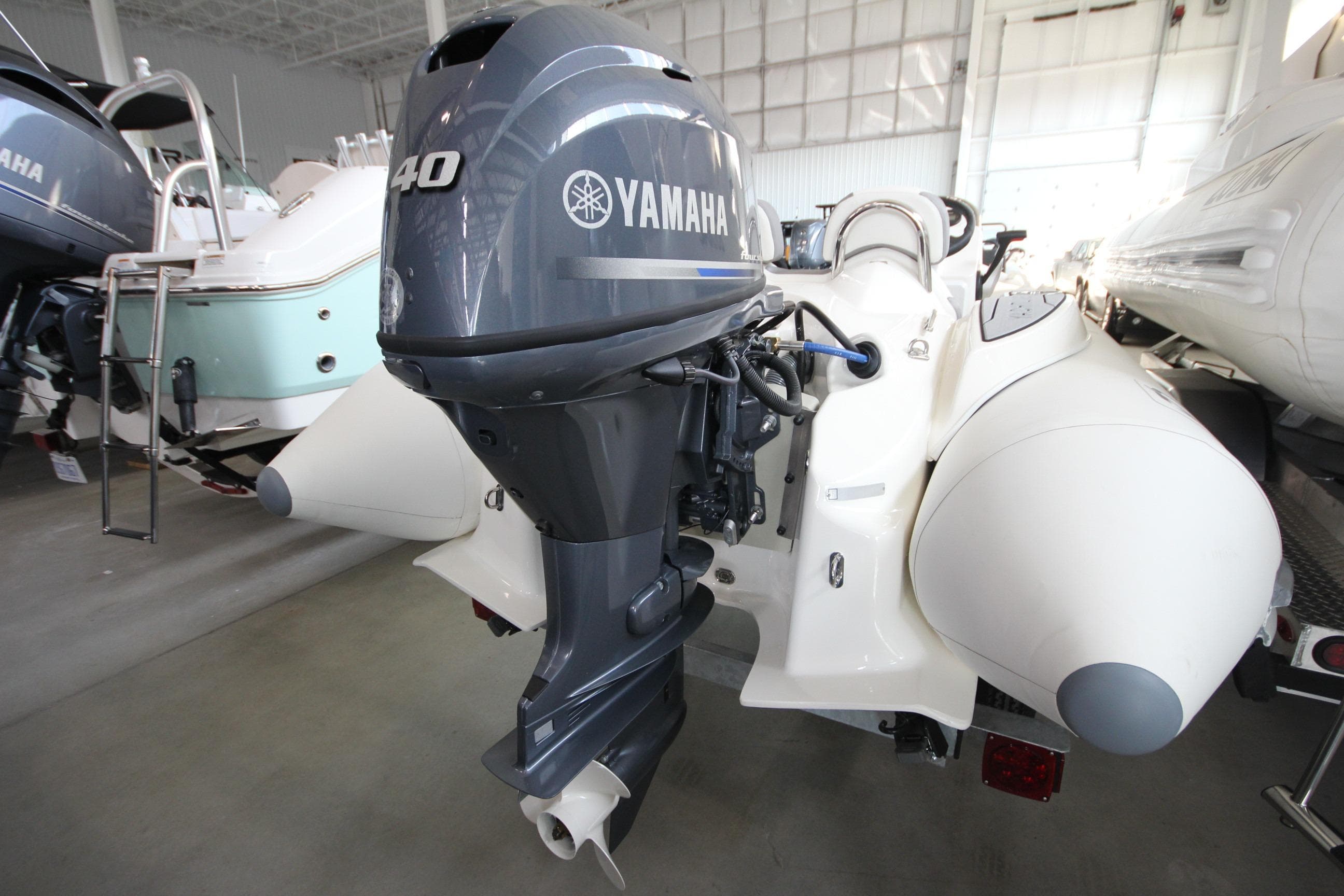 2026 Zodiac Yachtline Deluxe 360 with Yamaha outboard motor in showroom.