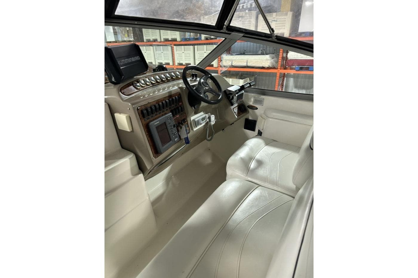2001 Maxum 3300 SCR boat cockpit with steering wheel and navigation equipment.