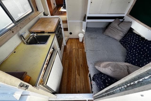 1978 Bruno & Stillman Custom Cruiser interior with kitchenette and cozy seating area.