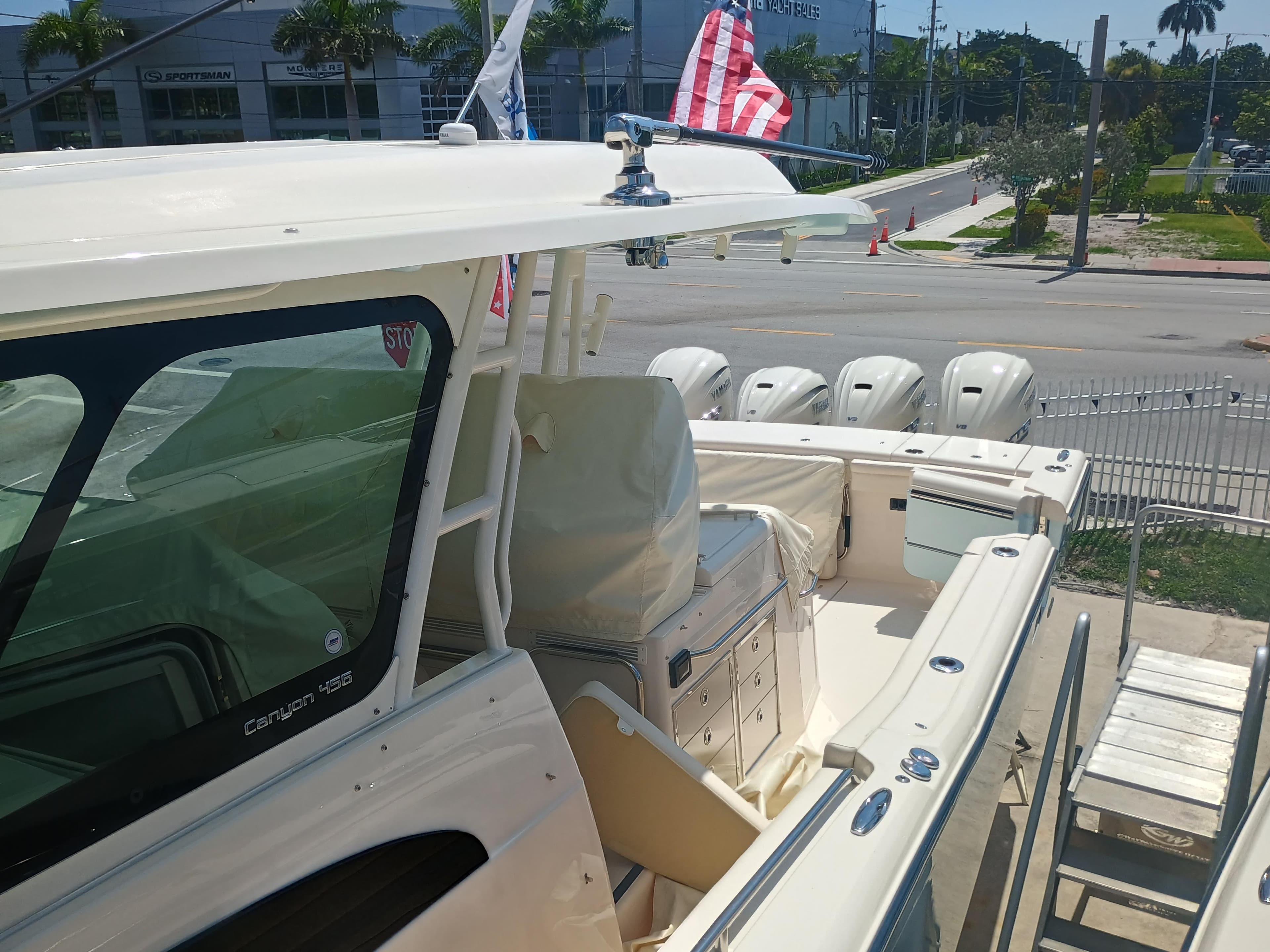 2025 Grady-White Canyon 456 boat with multiple engines, docked near a dealership.