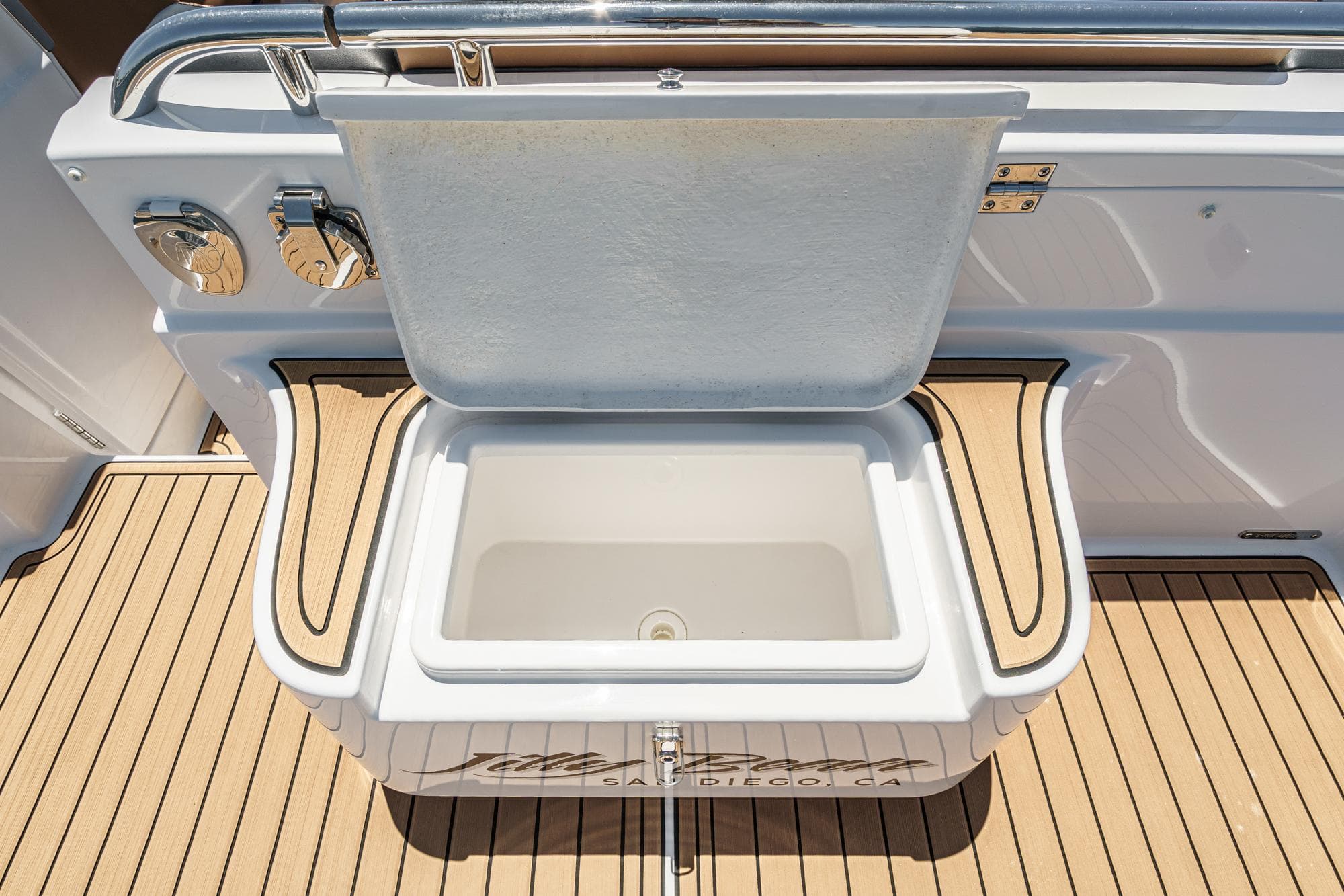 Open storage compartment on Airship 340 boat, 2025 model, with teak flooring.