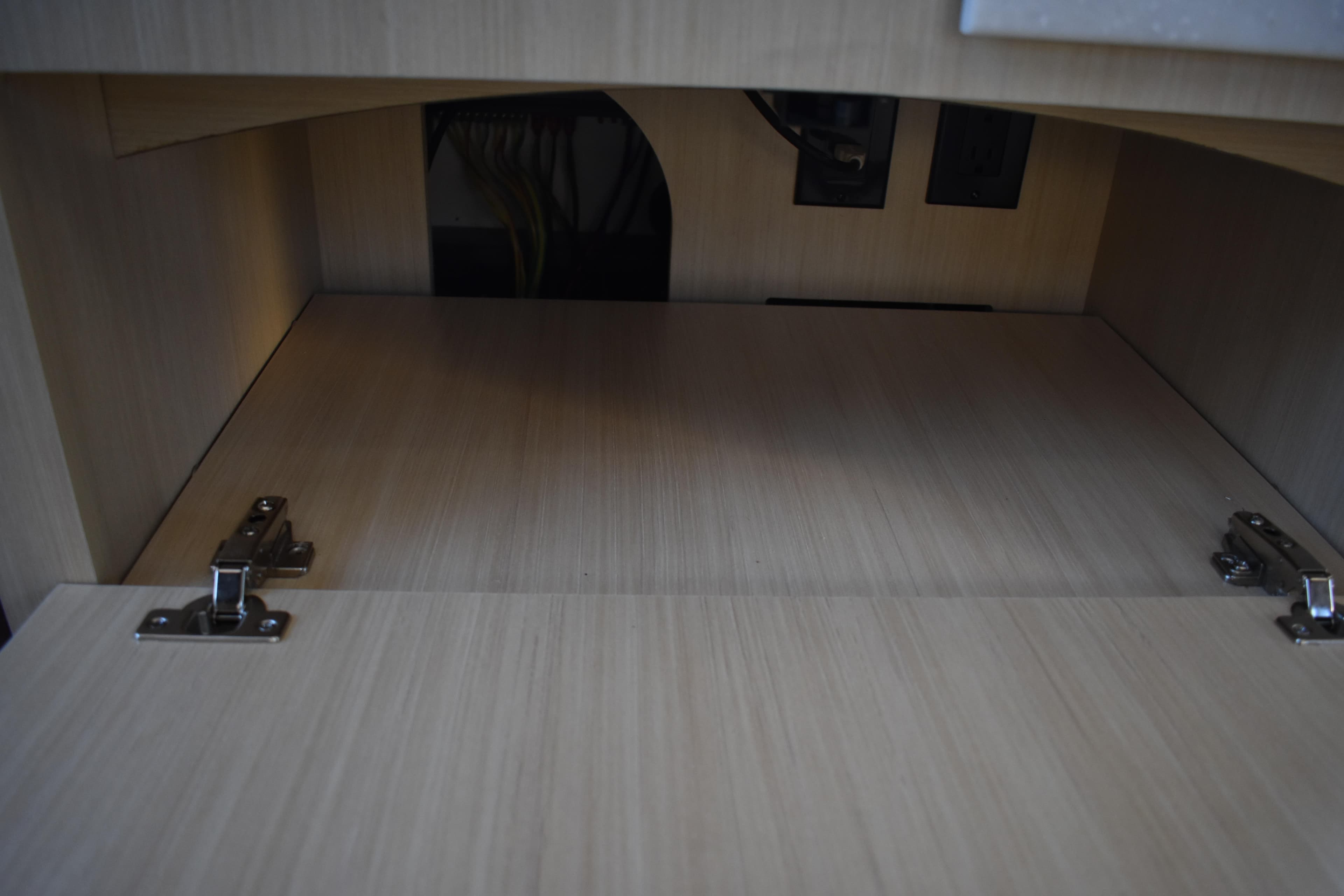 Empty wooden cabinet interior with hinges, Regal 38 FXO 2025 model.