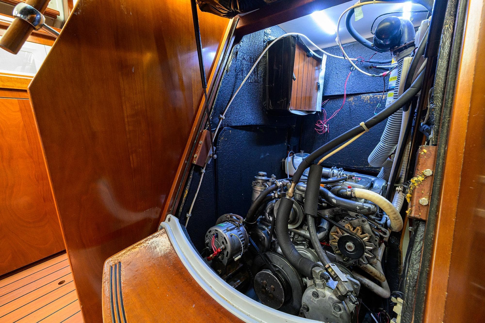 Engine room of a 2003 Beneteau 50 sailboat, showcasing mechanical components and wiring.