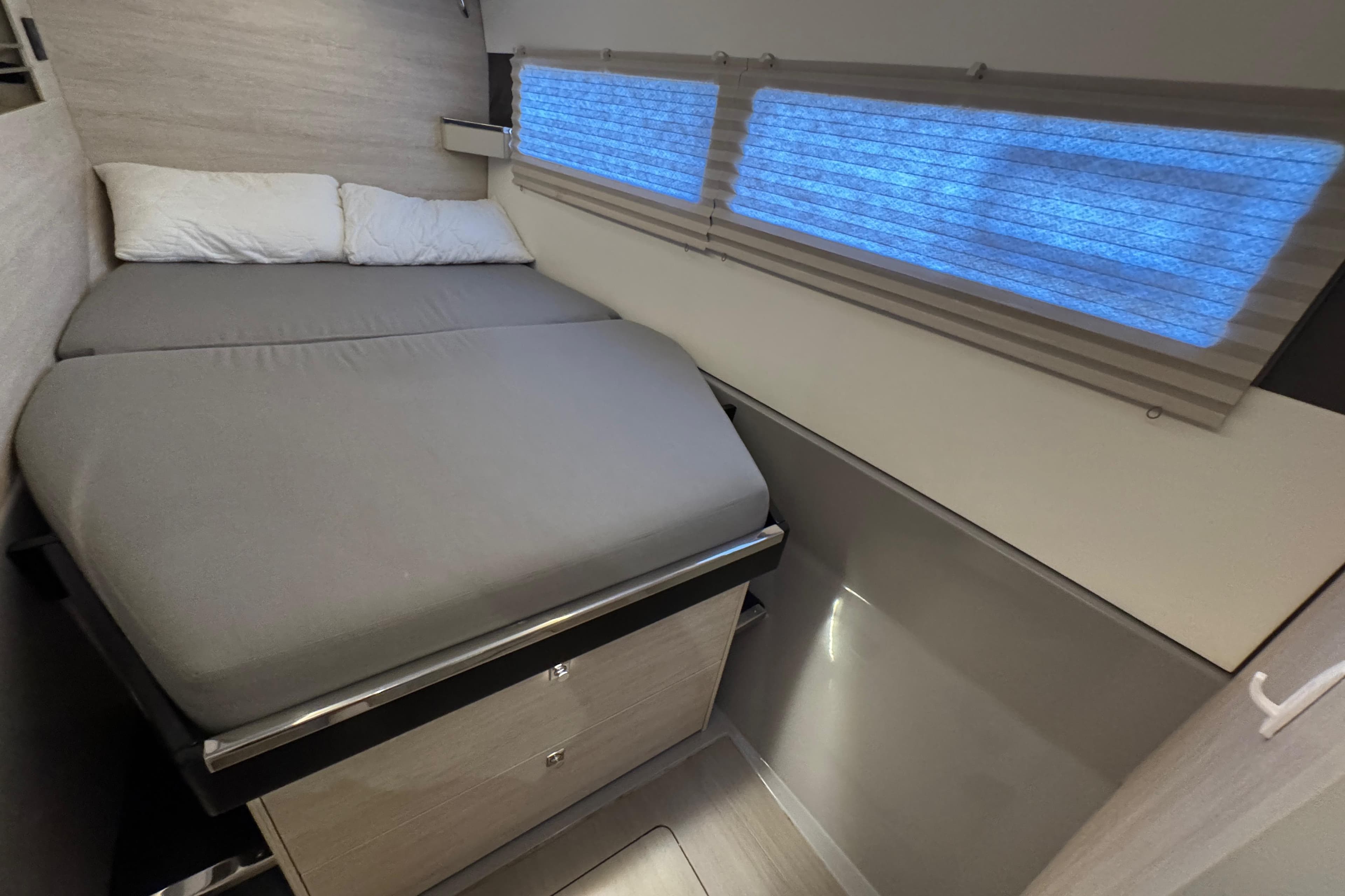 Cozy bedroom in 2021 Leopard 45 catamaran with modern design and soft lighting.