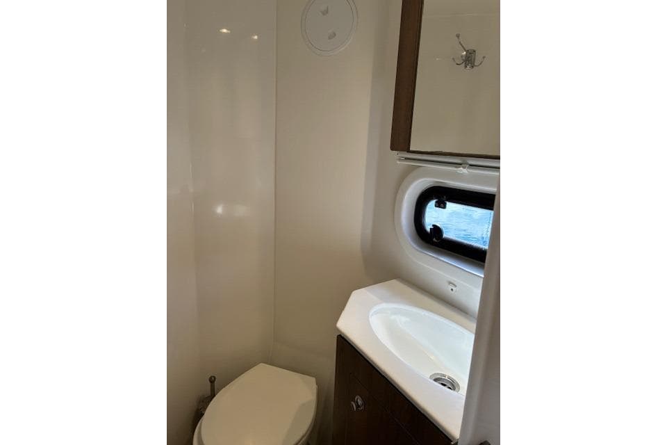 Compact bathroom in 2023 Bali 4.2 model with sink, toilet, and window.