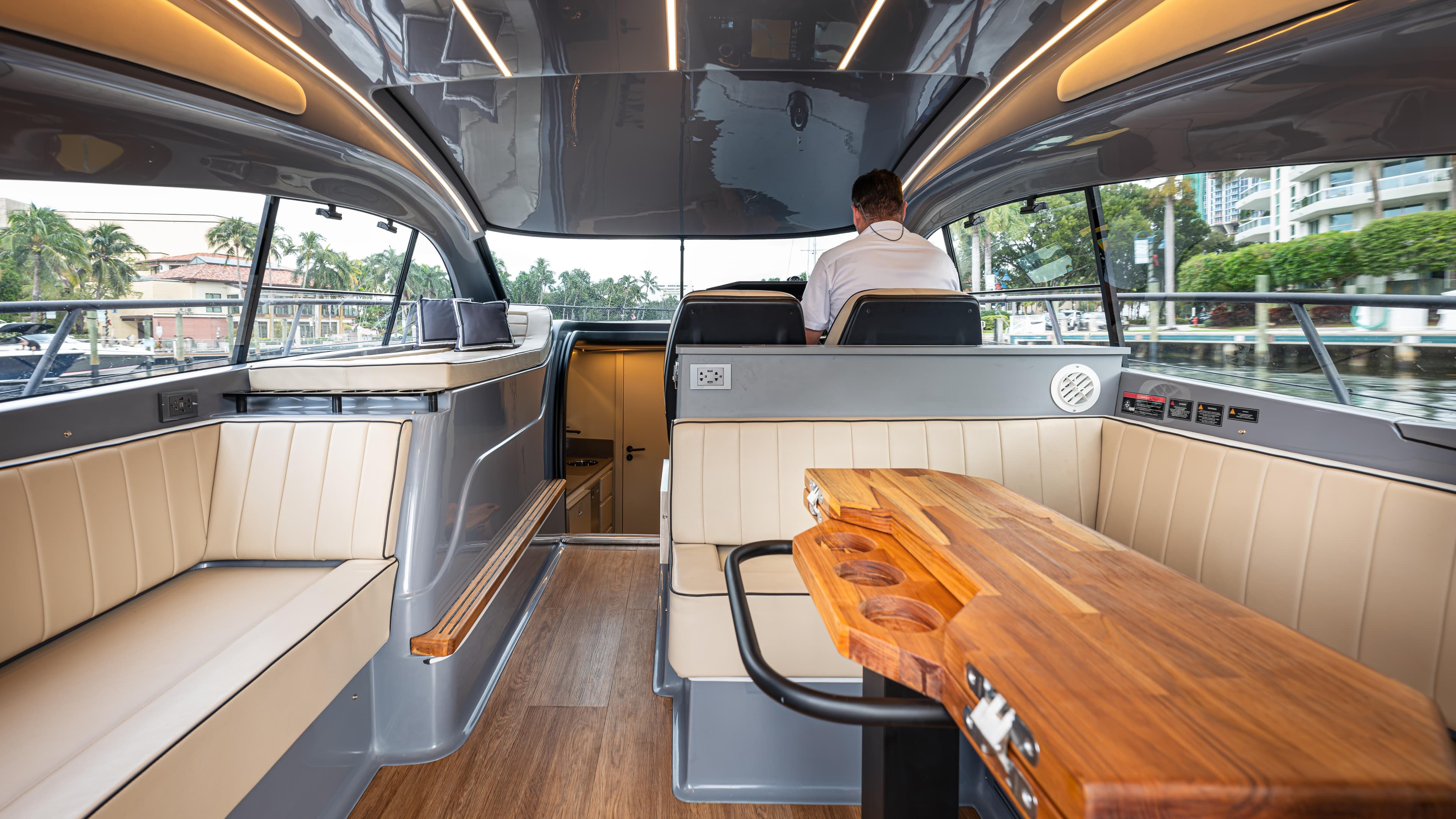 Luxurious interior of 2025 Hanover 415 yacht with modern seating and wooden table.