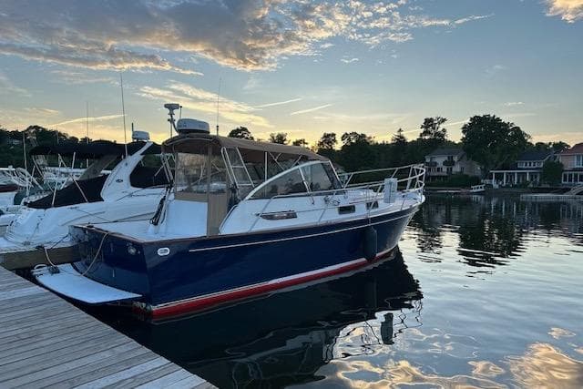2001 Legacy Yachts Express docked at sunset, reflecting on calm water.