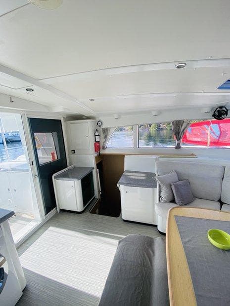 Interior of 2010 Lagoon 440 catamaran, featuring modern seating and dining area.