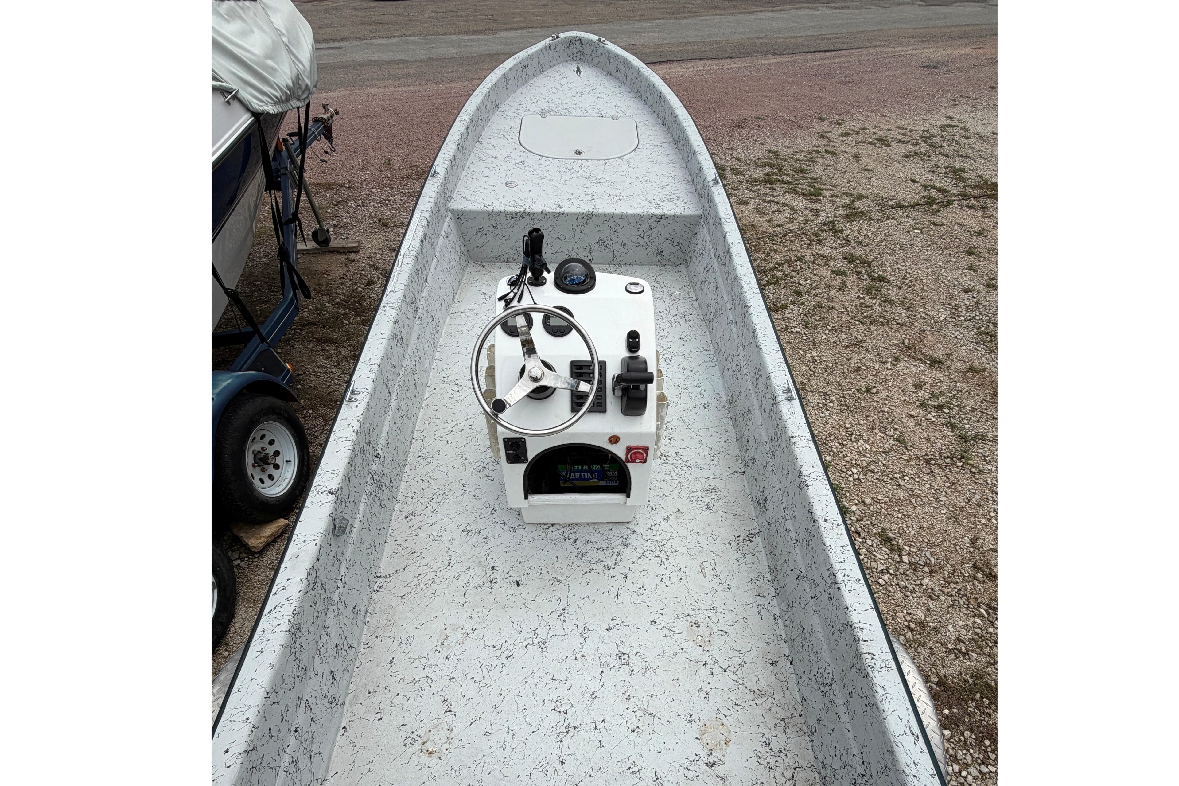2018 Panga Imemsa W-23II boat interior with steering console, parked on gravel.
