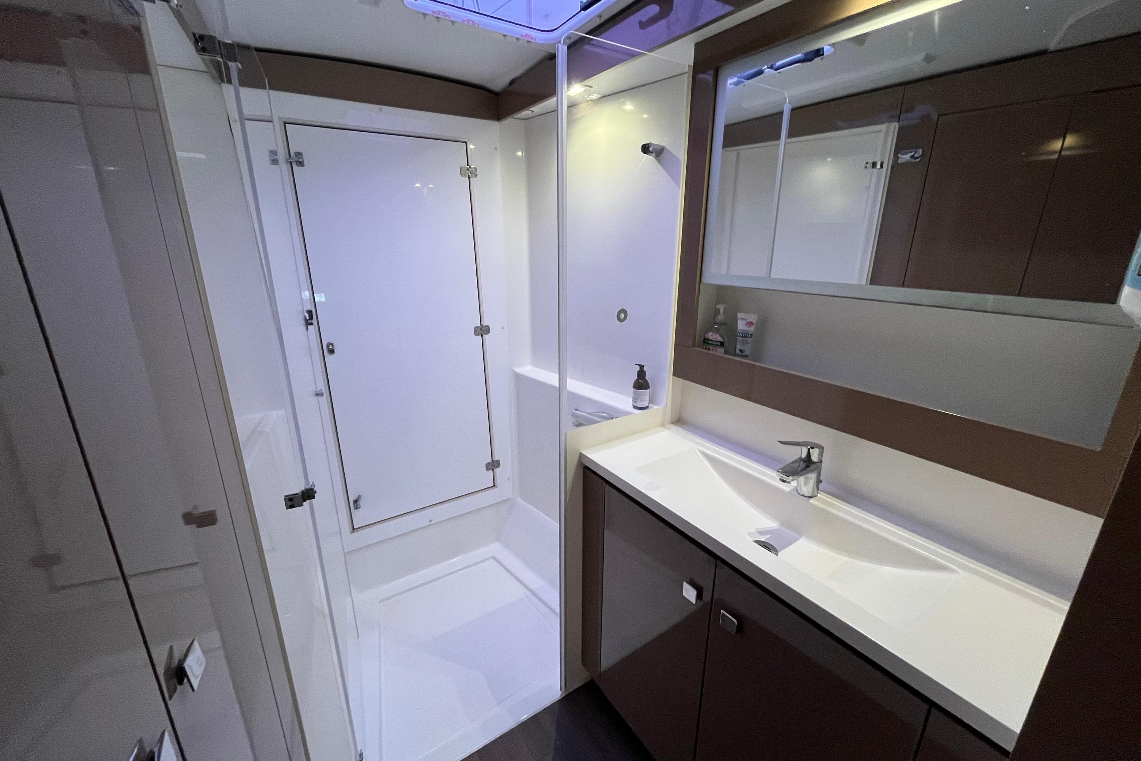 Modern bathroom interior of 2017 Fountaine Pajot Lucia 40 catamaran.