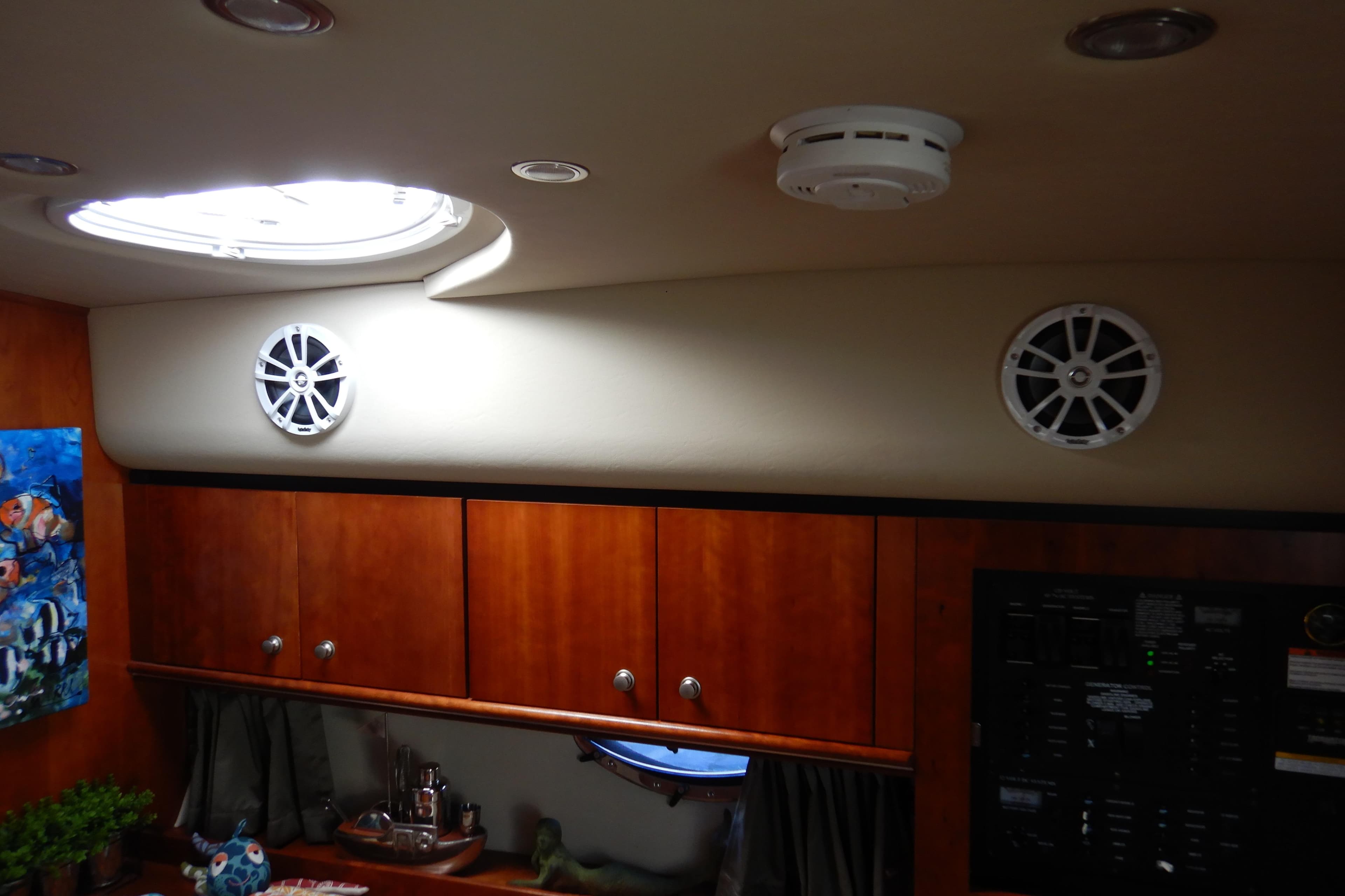 2007 Cruisers 340 Express cabin interior with wood cabinets and ceiling speakers.