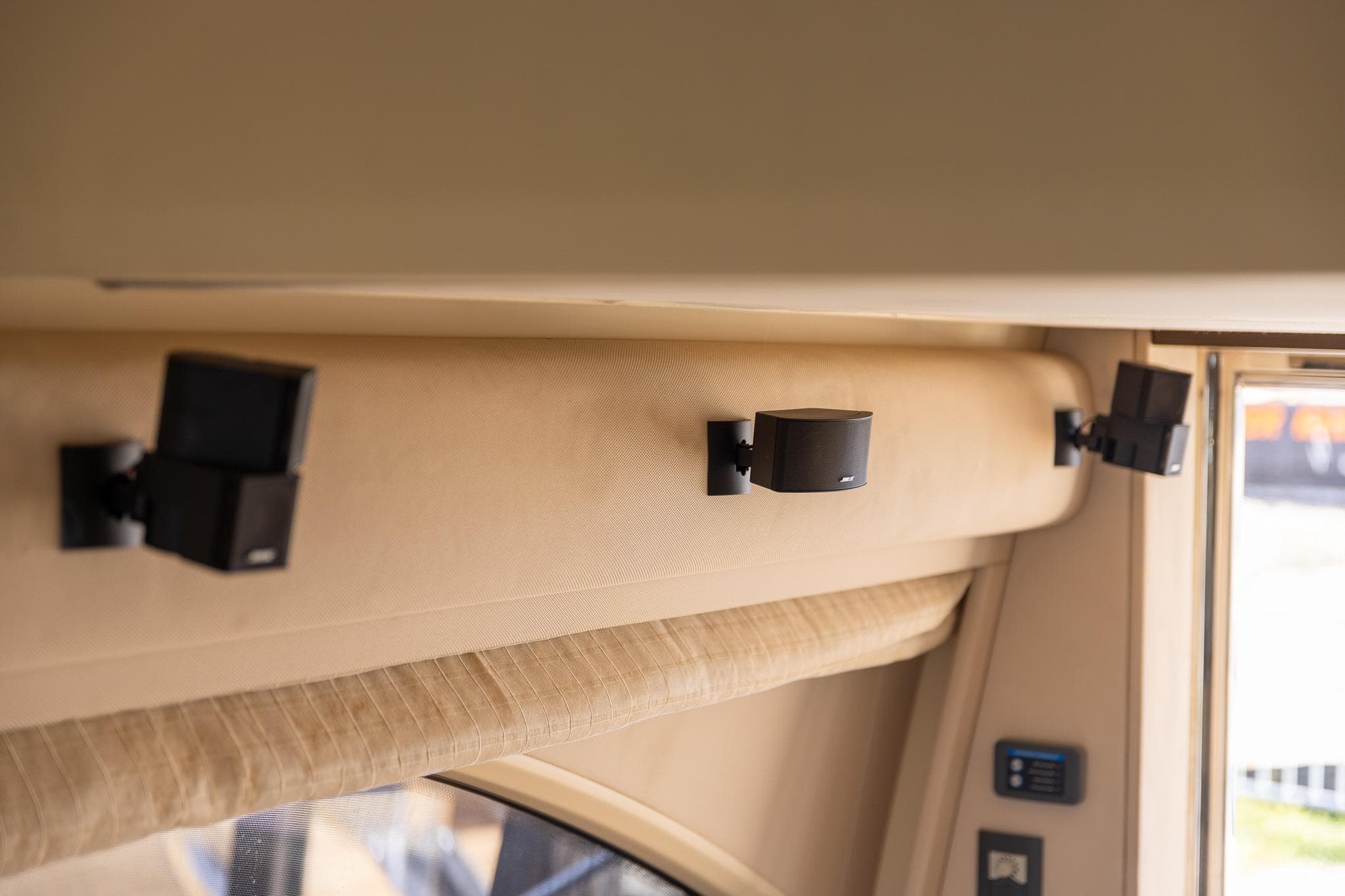 Interior speakers on 2014 Azimut 54 Flybridge yacht, mounted on beige wall.