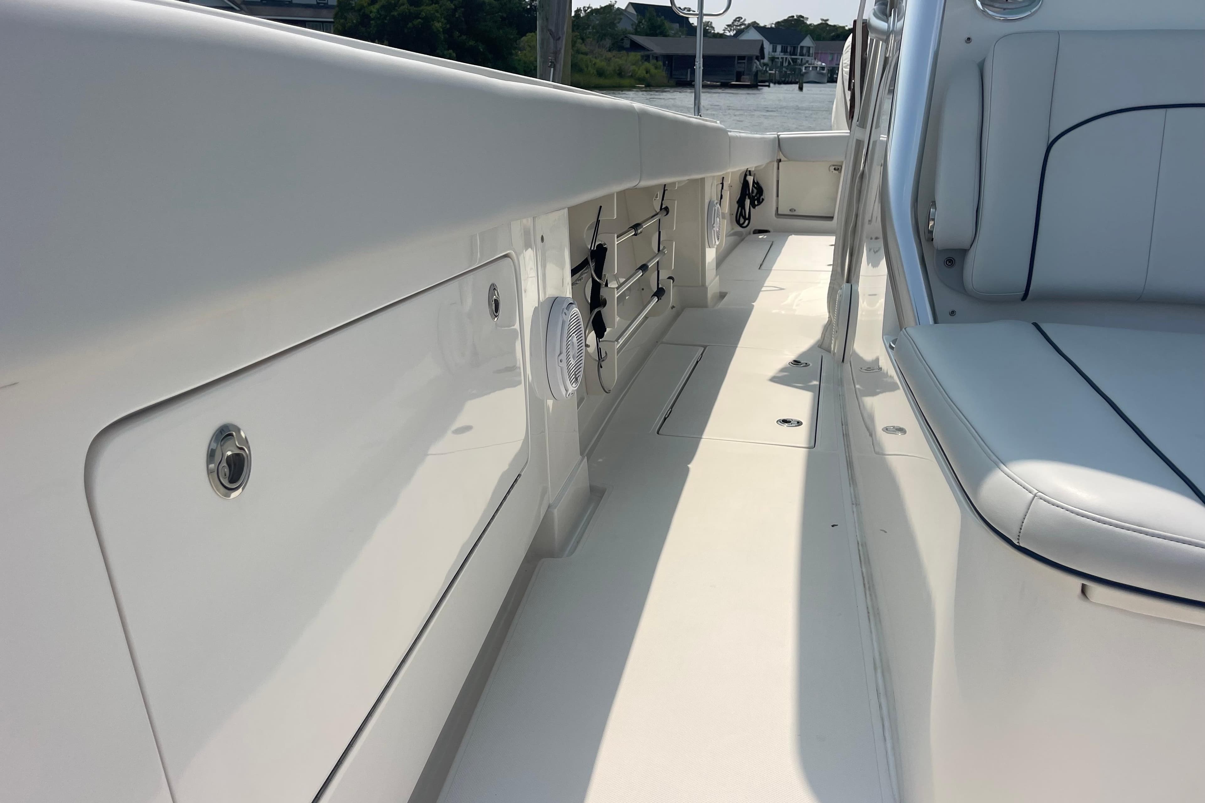 2020 Jupiter 38 boat interior with white seating and storage compartments.