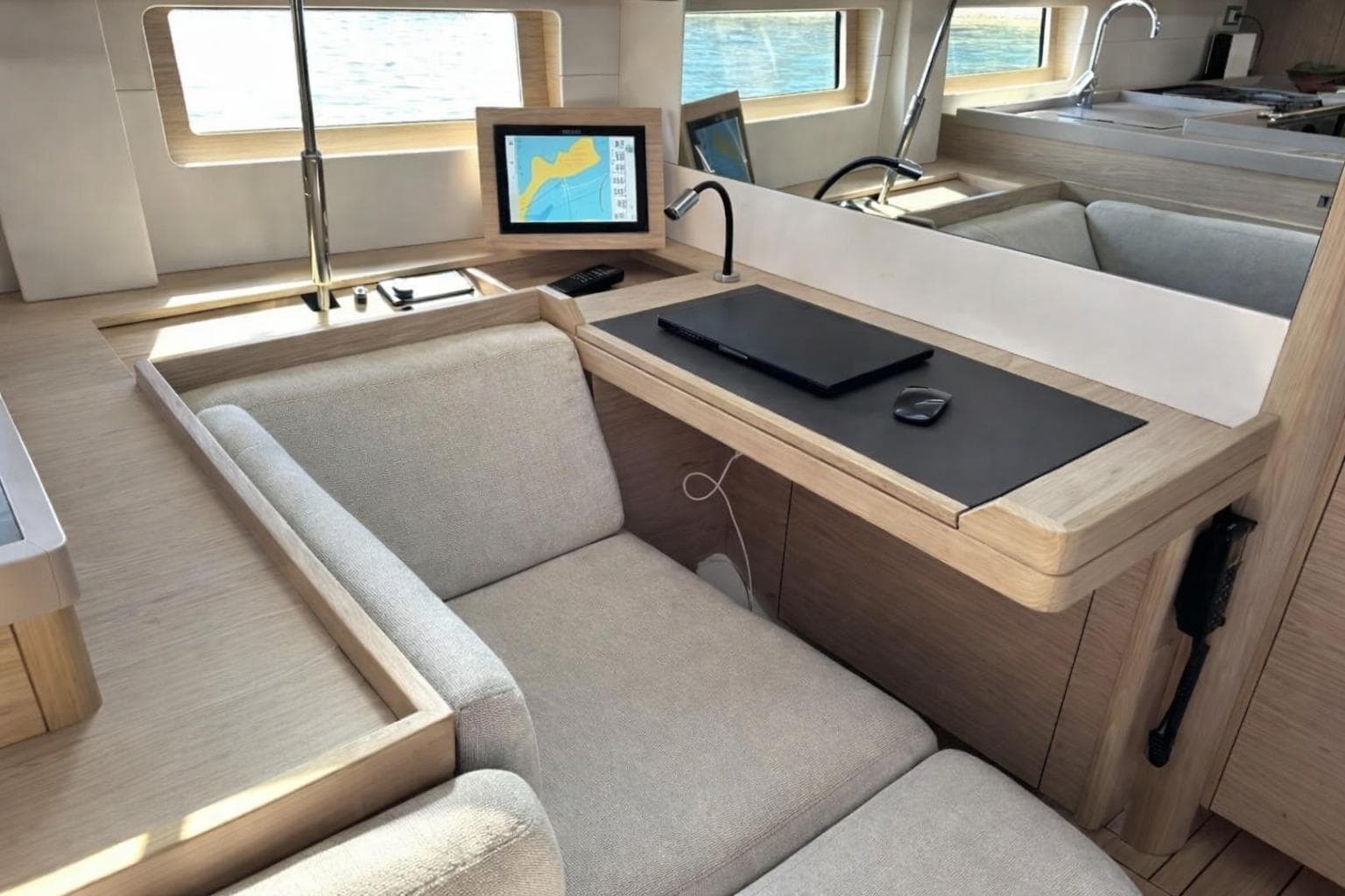 Luxurious interior of 2019 Beneteau Oceanis 51.1 yacht with navigation station and seating.