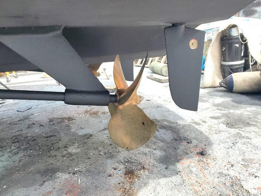 Propeller and rudder of a 1998 Viking Sports Cruiser on dry dock.