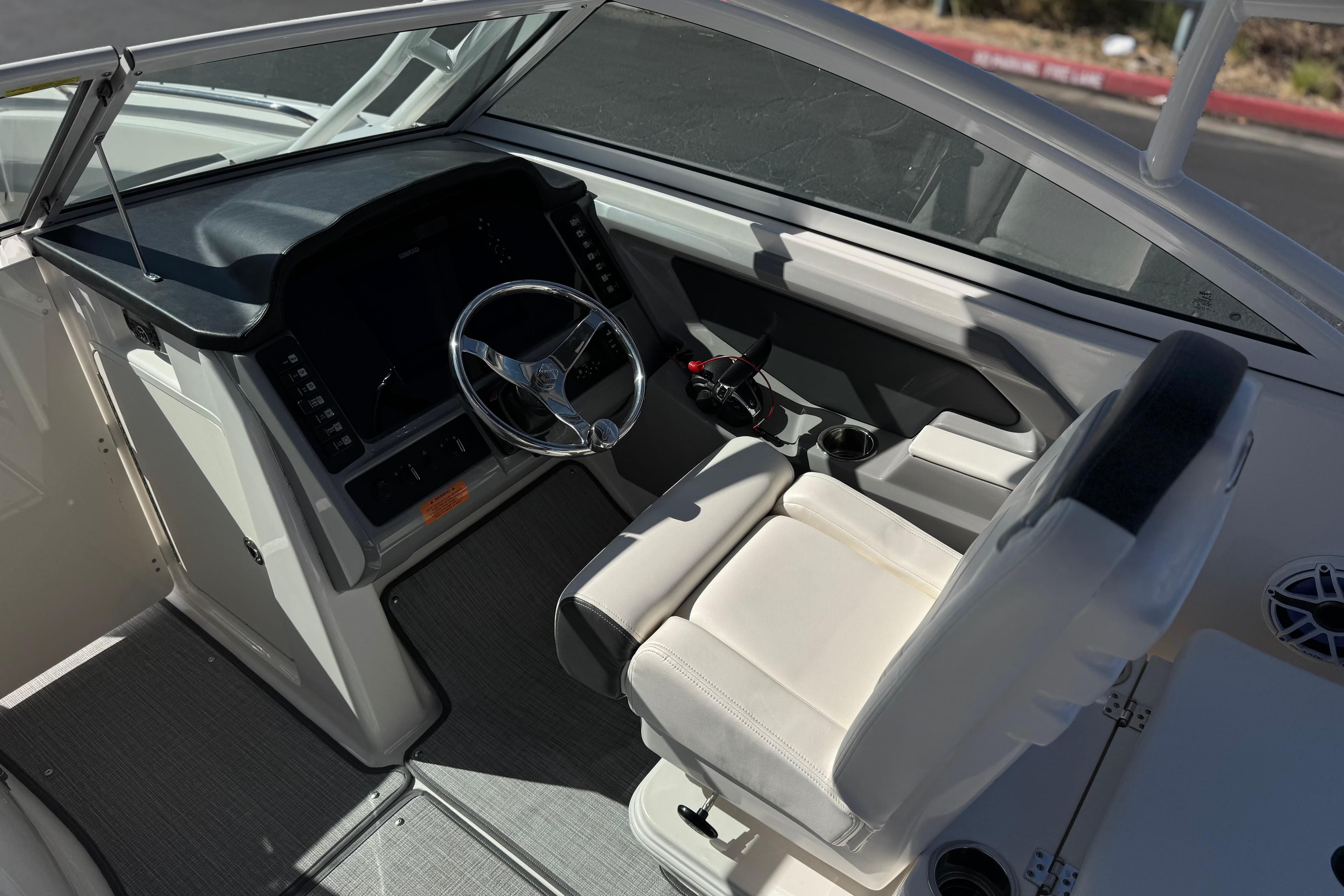 2022 Robalo R247 Dual Console boat interior with steering wheel and seating.
