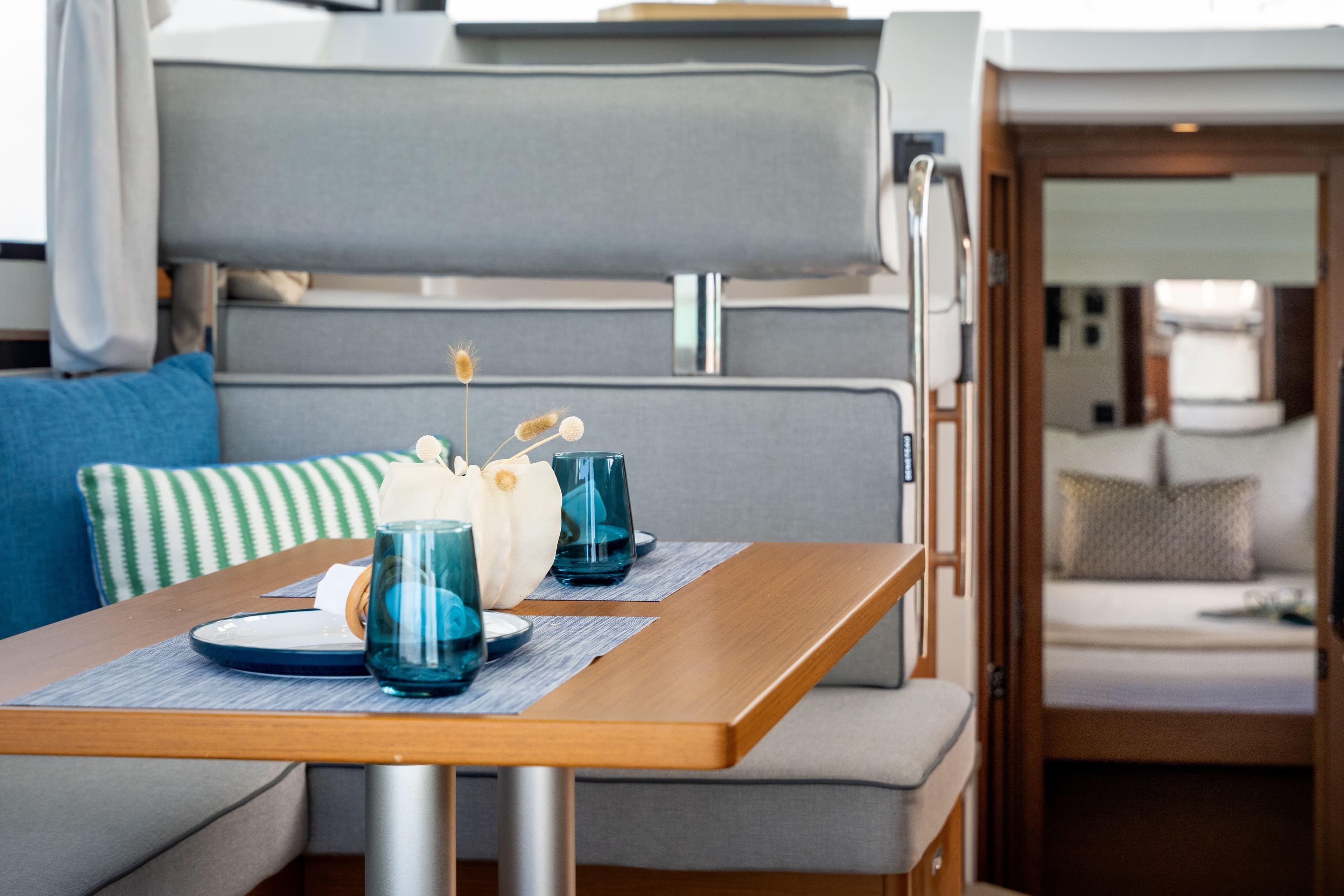 Interior of 2026 Beneteau Swift Trawler 37 Fly, featuring elegant dining area with blue accents.