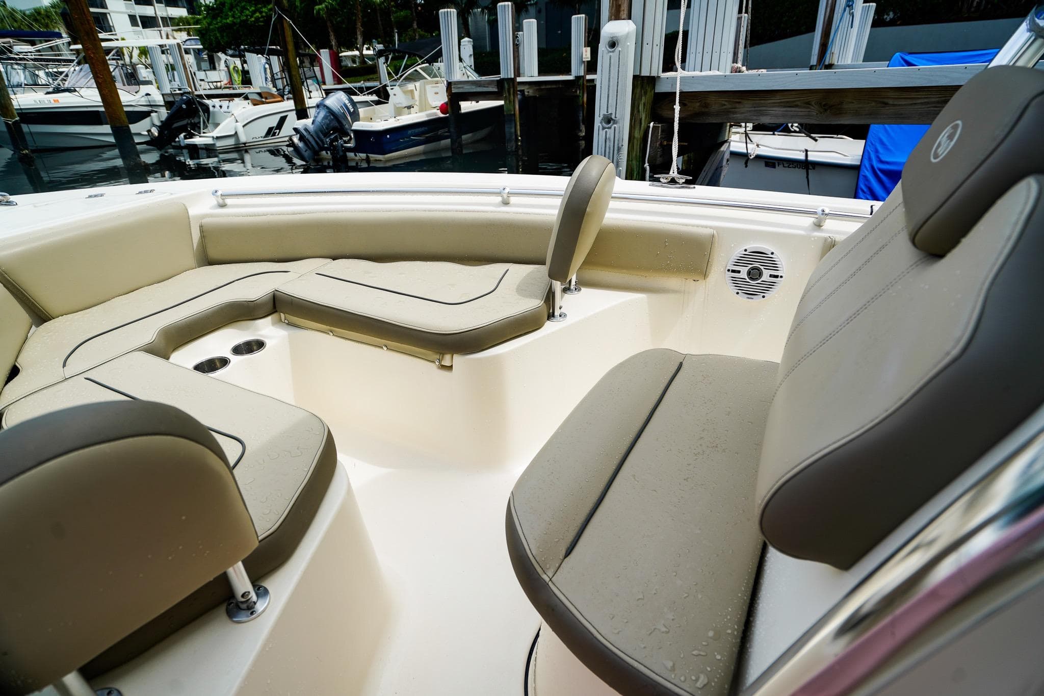 2022 Key West 219 FS boat interior with cushioned seating and cup holders.