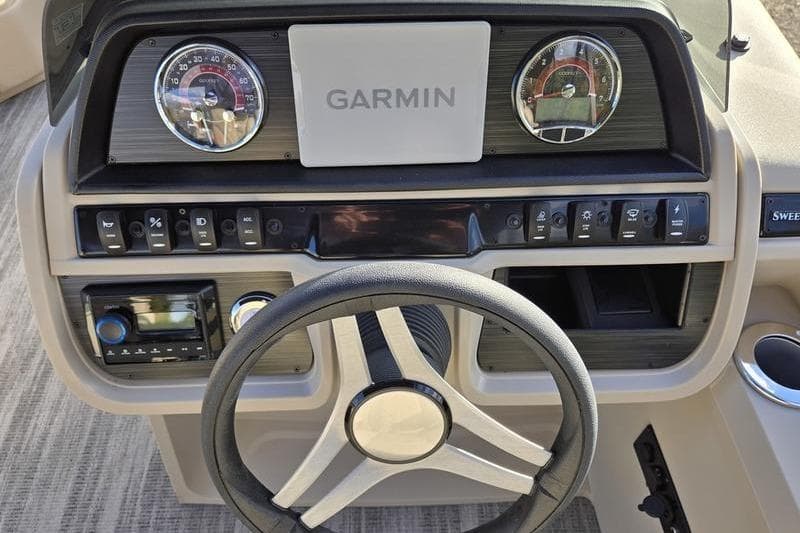 2025 Godfrey Sweetwater 2286 QS dashboard with Garmin display and steering wheel.