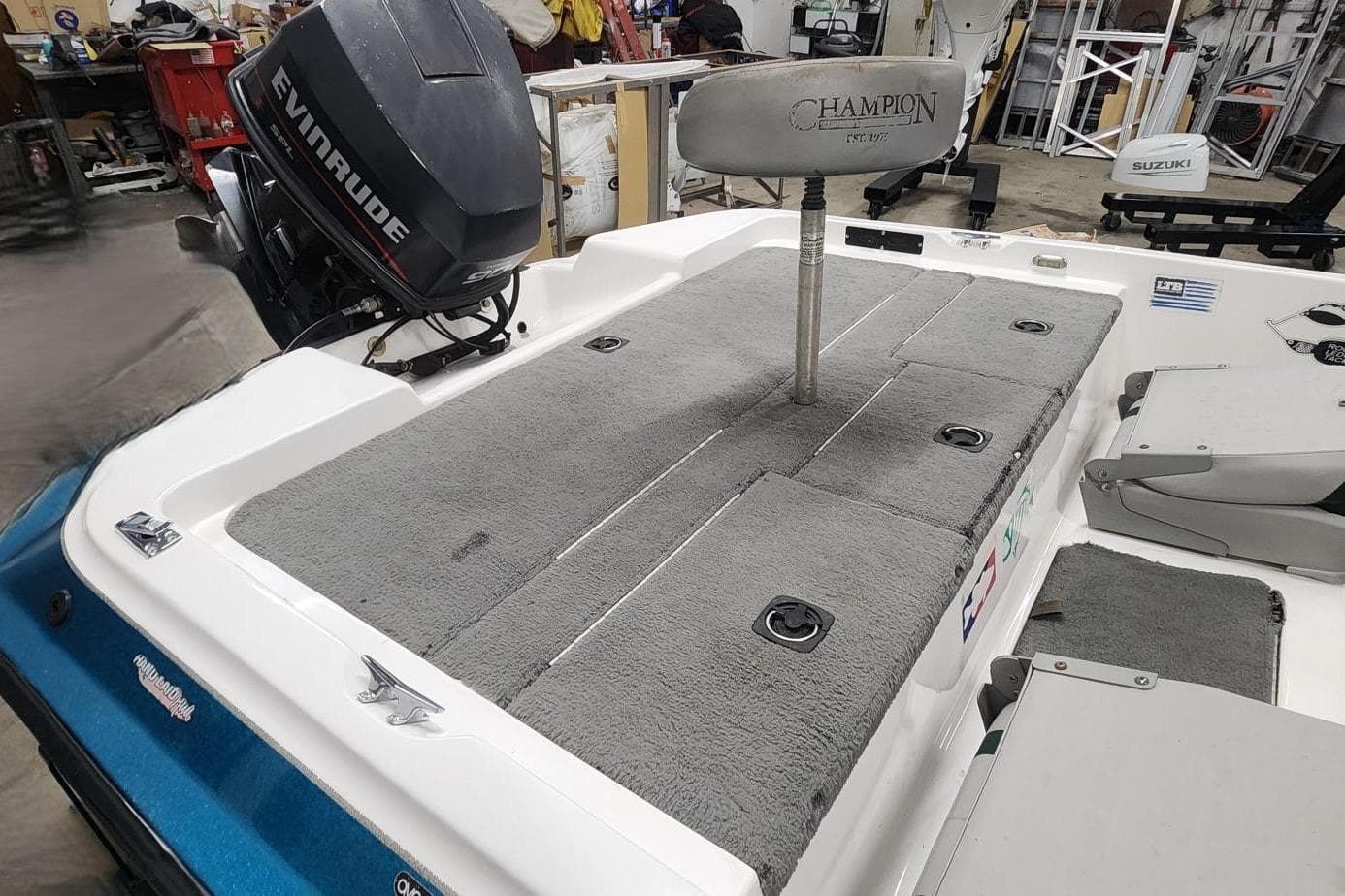 1997 Stratos 268V 17' SC Bass Boat with Evinrude motor in a workshop setting.