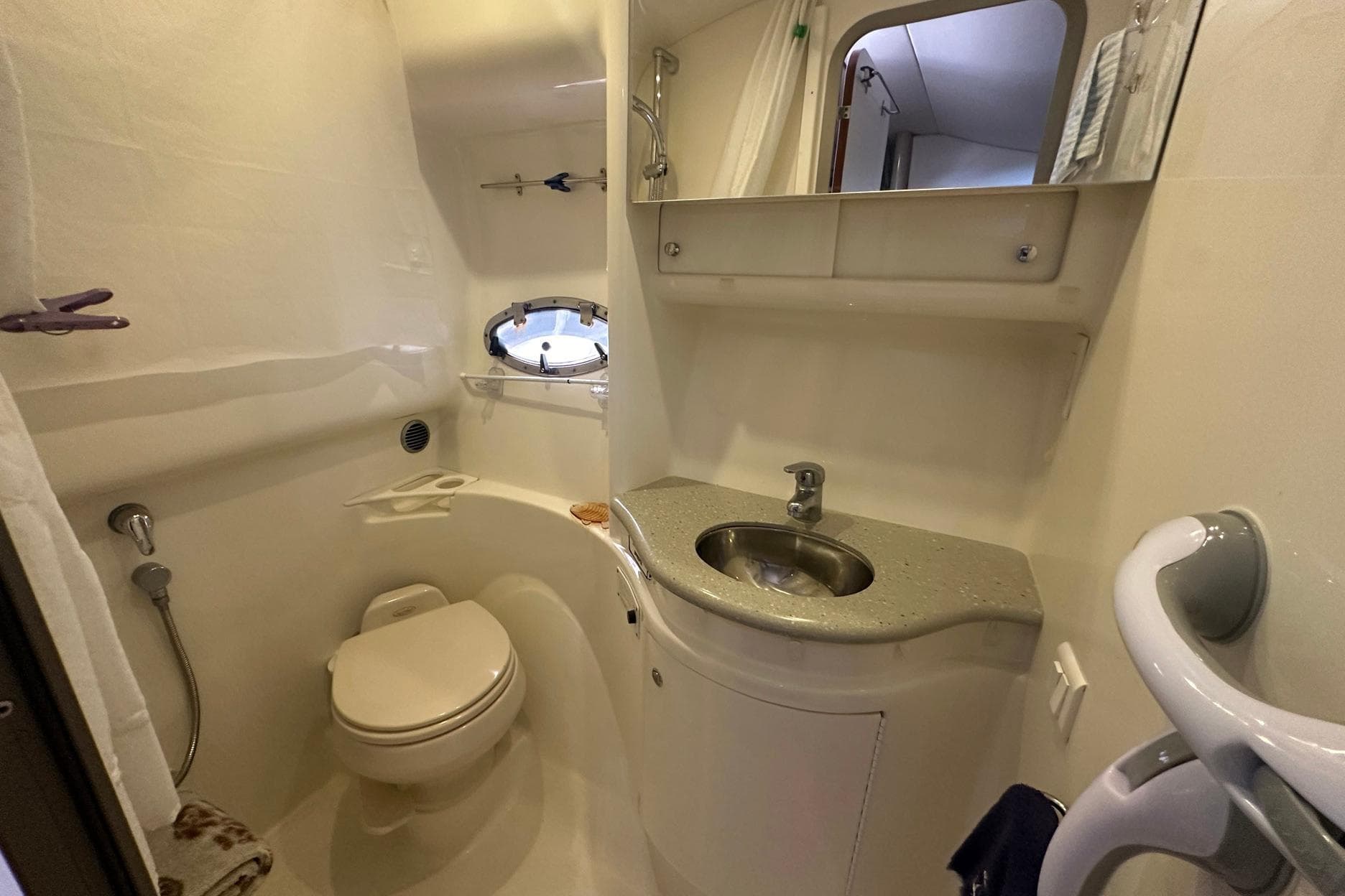 2005 Formula 37 PC yacht bathroom with sink, toilet, and porthole window.