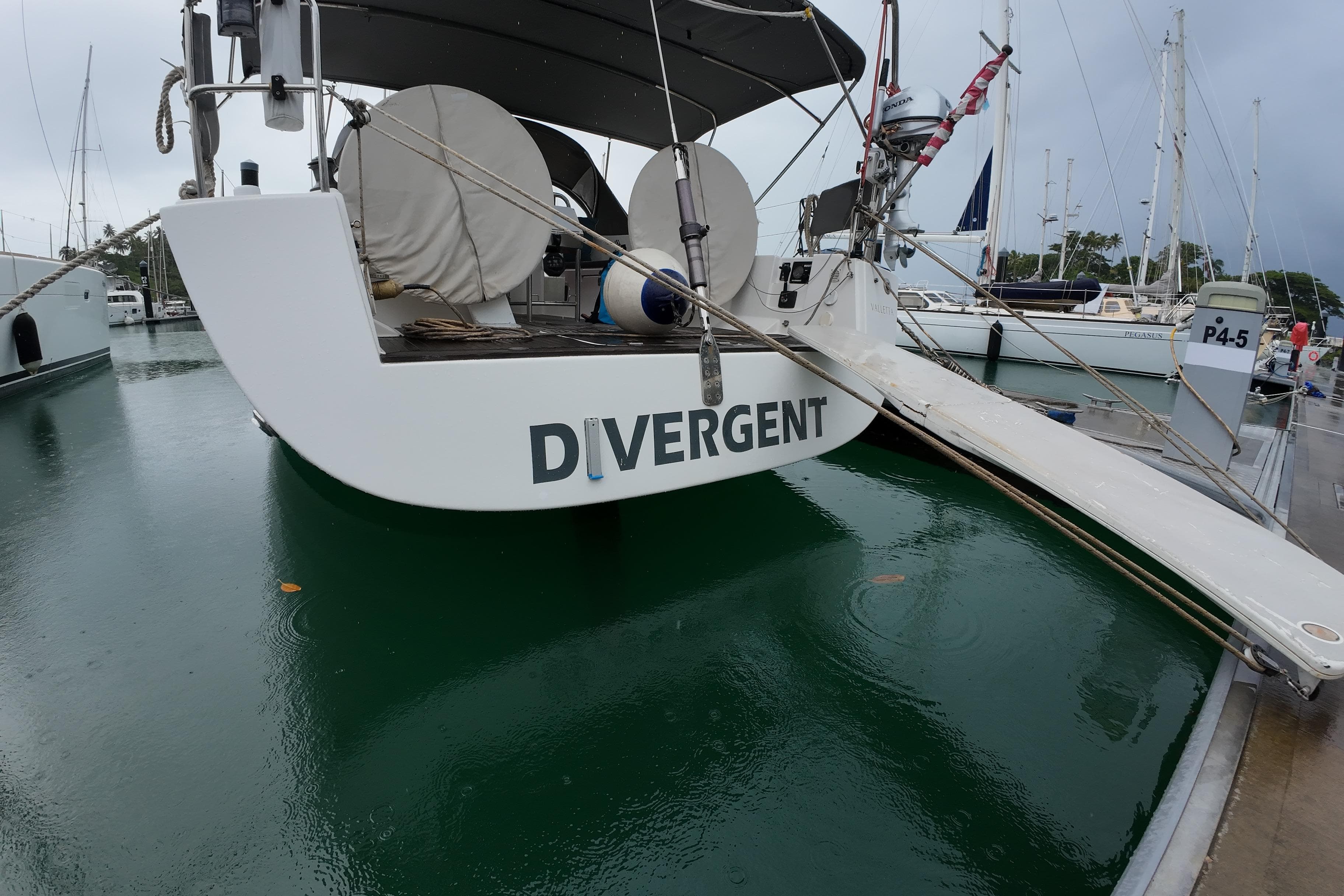 Hanse 430e 2007 sailboat named "Divergent" docked at marina, rear view.