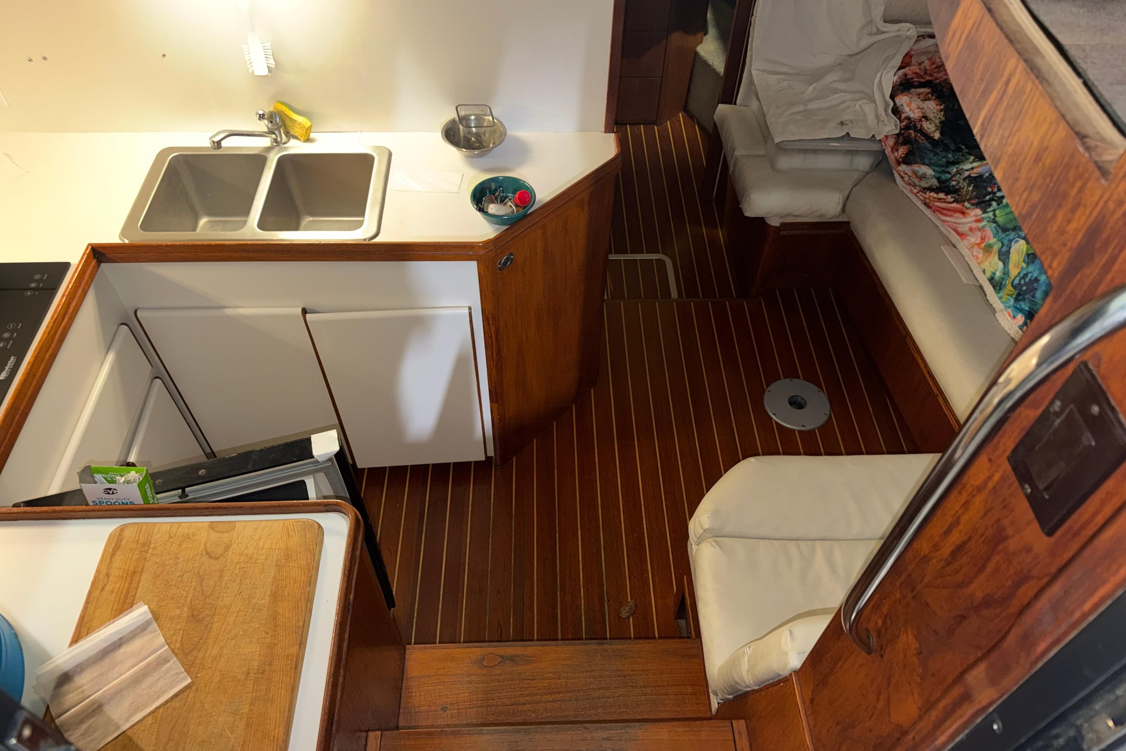 1989 Tiara Yachts 3600 Open interior with kitchenette and seating area.