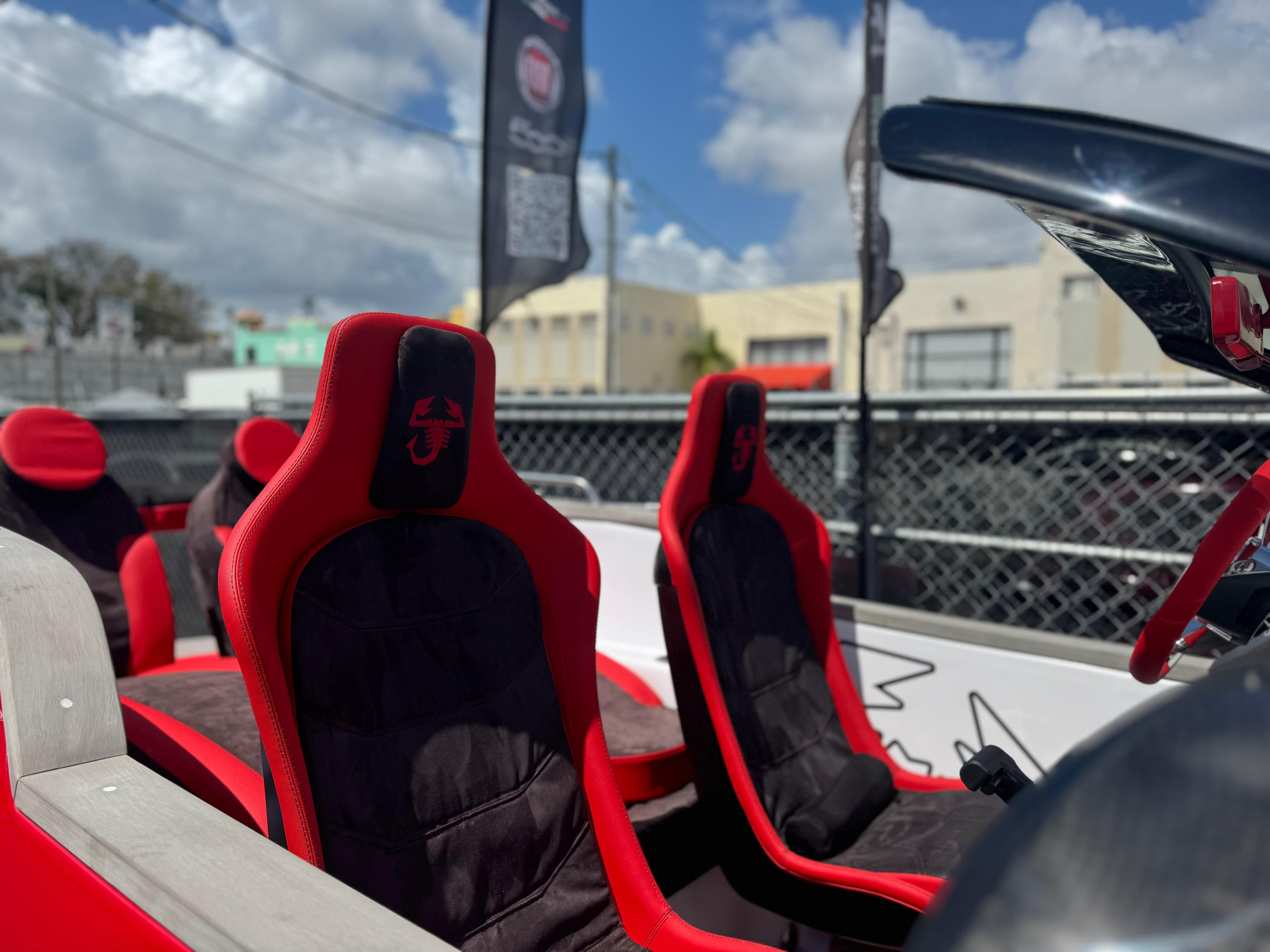 2025 Car Off-shore Fiat 500 Abarth seats, red and black design, outdoor setting.