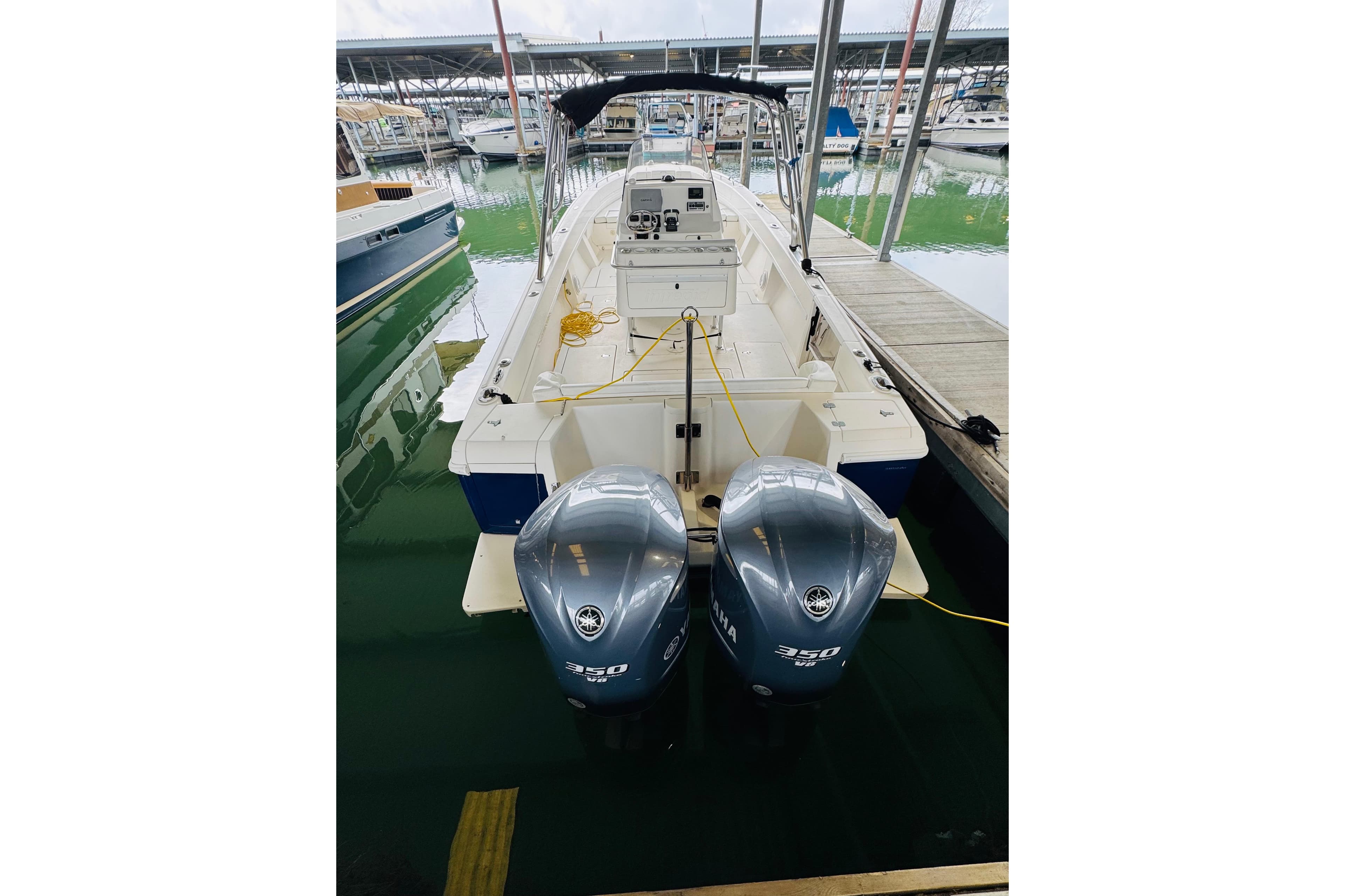 2008 Intrepid 327 boat with dual Yamaha 350 engines docked at marina.
