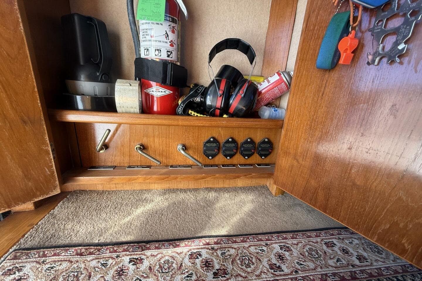 Interior storage of 2000 Royal Pacific 476 Sport Cruiser with safety equipment and controls.